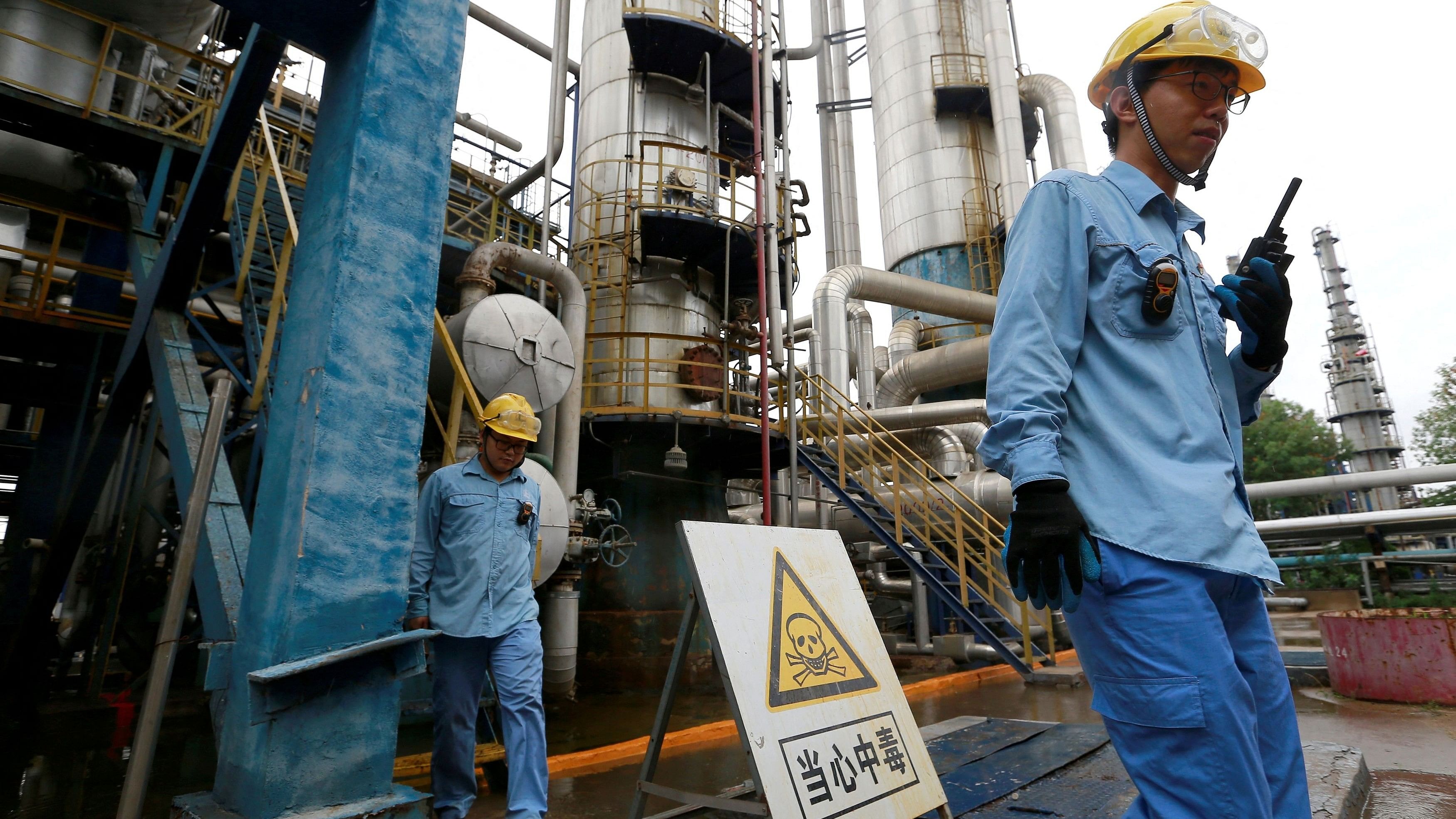 <div class="paragraphs"><p>FILE PHOTO: Technicians seen at a refinery that produces ethanol gasoline for vehicles, at China's Petroleum and Chemical Corporation, or Sinopec, Tianjin company, in Tianjin, China.</p></div>