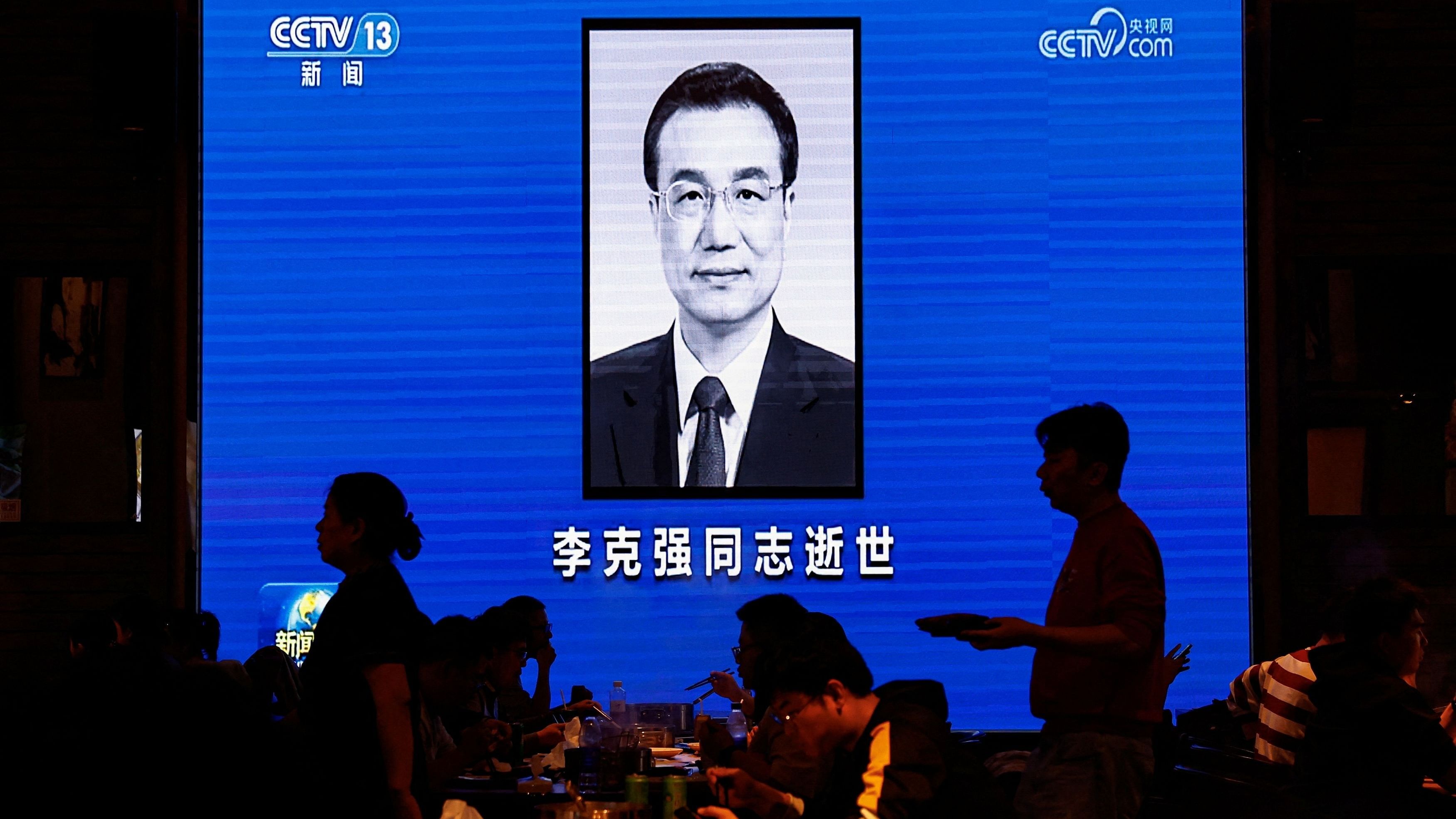 <div class="paragraphs"><p>People dine near a screen broadcasting obituary of China's former Premier Li Keqiang during the evening news, following his death, at a restaurant in Beijing.</p></div>