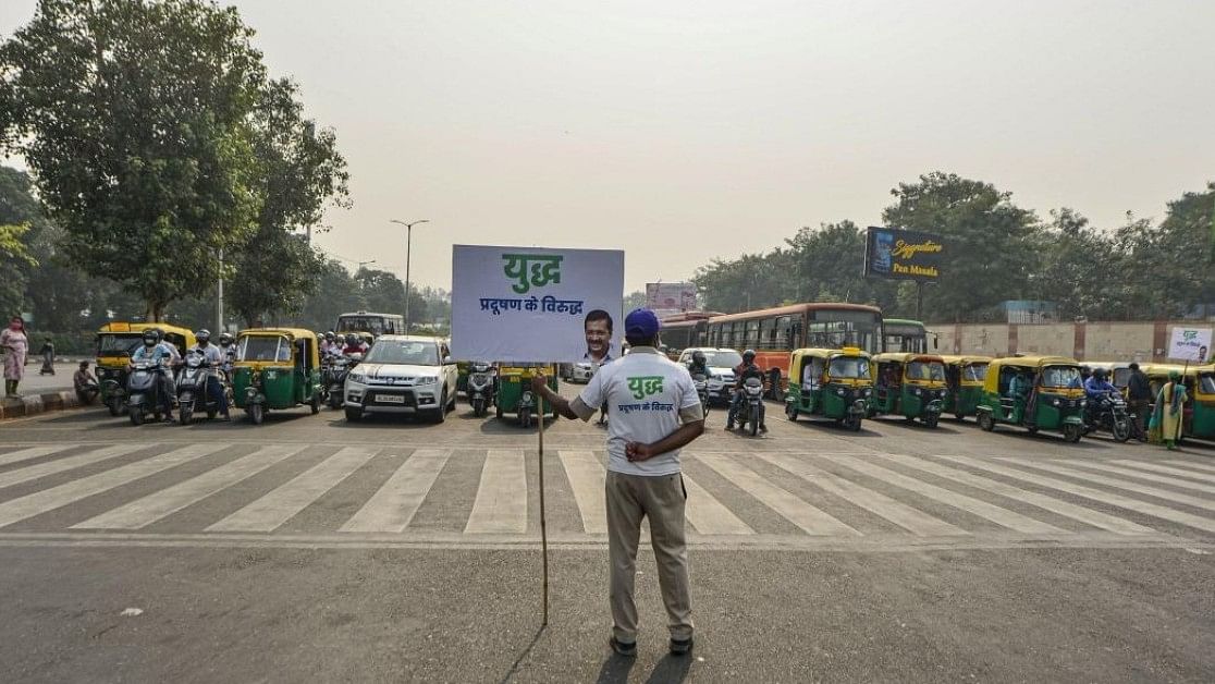 <div class="paragraphs"><p>A Civil Defence volunteer holds a placard during 'Red Light On, Gaadi Off' campaign in New Delhi.</p></div>