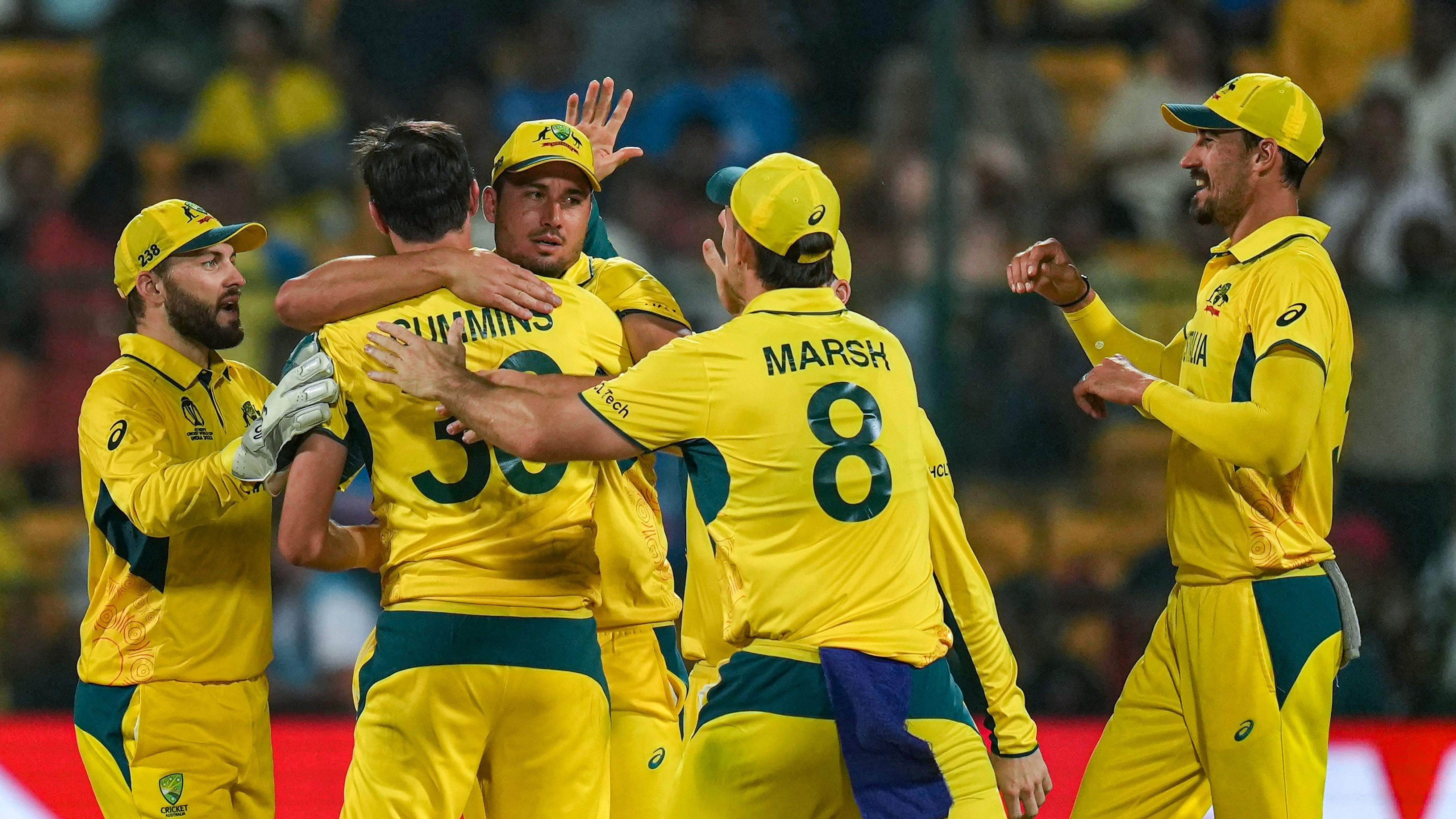 <div class="paragraphs"><p>Australia's Pat Cummins celebrates with teammates after taking the wicket of Pakistan's Saud Shakeel during the ICC Men's Cricket World Cup 2023 match between Pakistan and Australia at M. Chinnaswamy Stadium, in Bengaluru, Friday, Oct. 20, 2023.</p></div>