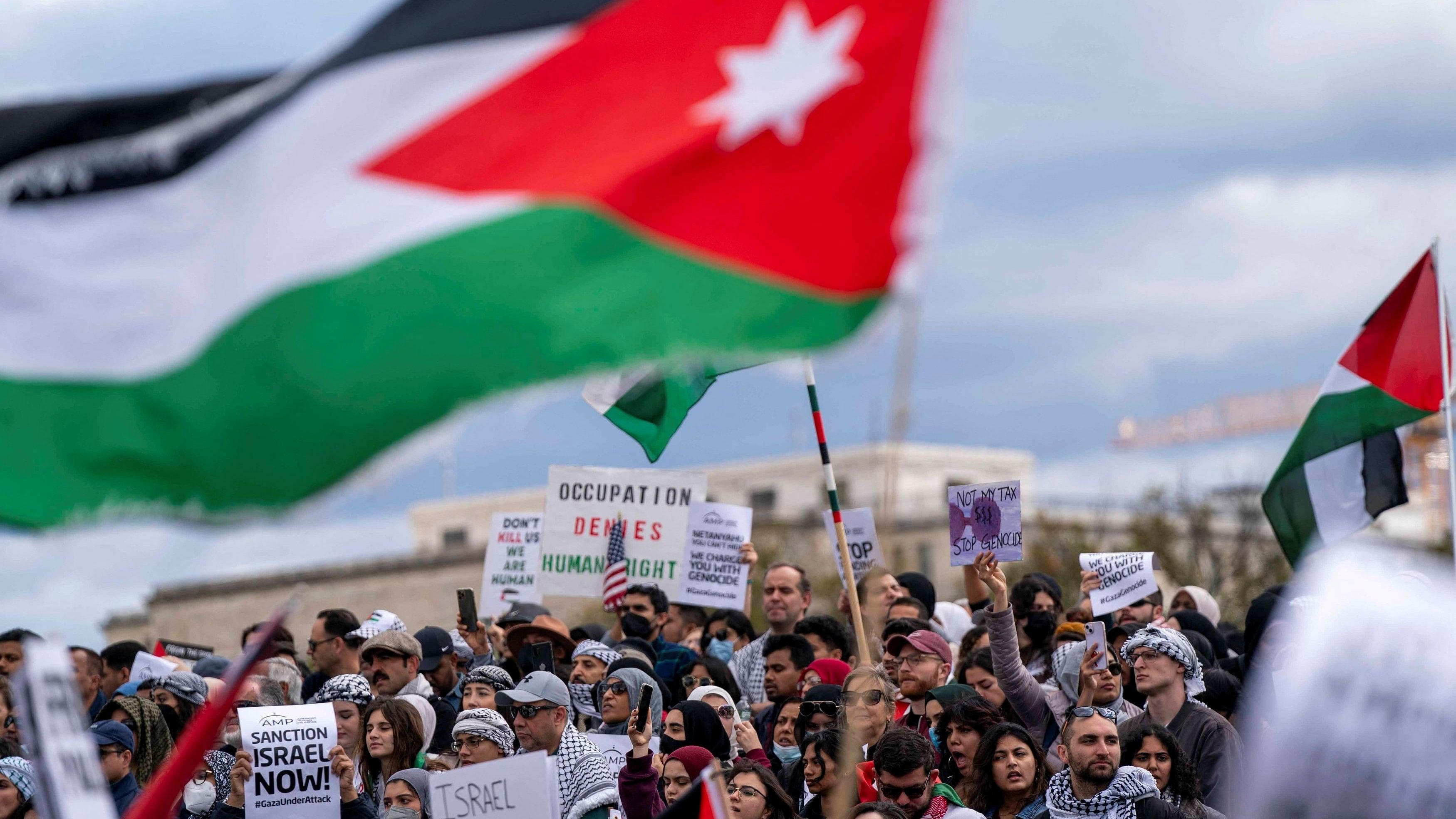 <div class="paragraphs"><p>People raise flags and posters during a rally held by American Muslims for Palestine calling for a cease fire in Gaza near the Washington Monument in in Washington, US, October 21, 2023.  </p></div>