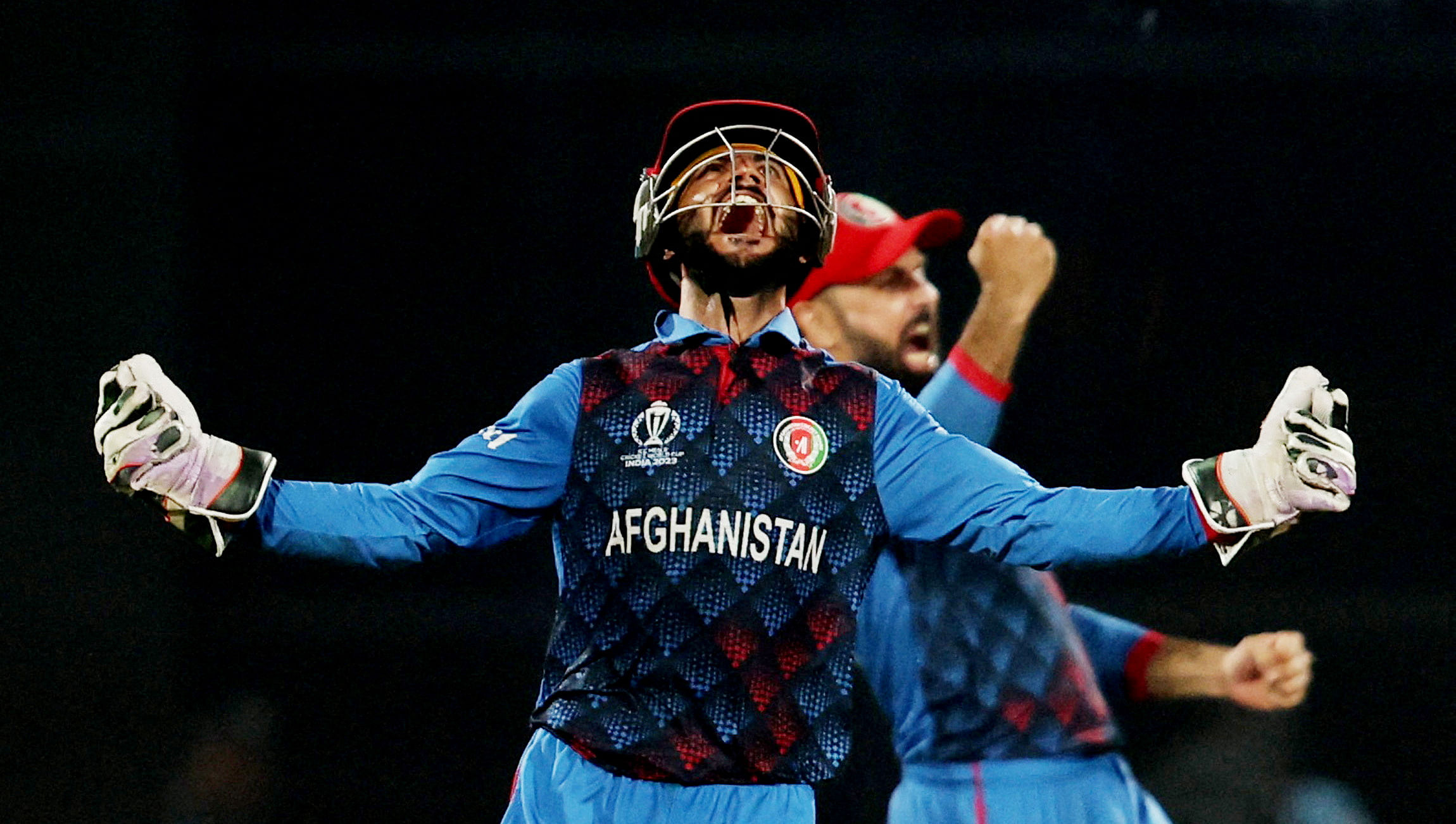 <div class="paragraphs"><p> Afghanistan's Ikram Alikhil celebrates after Rashid Khan bowls out England's Mark Wood to win the match.</p></div>