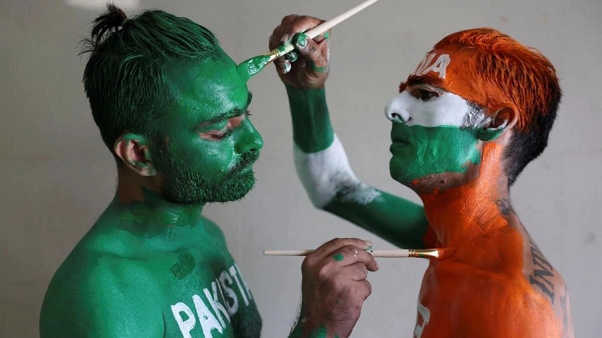 <div class="paragraphs"><p>Cricket fans, Arun Haryani (Right) and Anil Advani (Left) paint their bodies in the Indian and Pakistani national flag colours.</p></div>