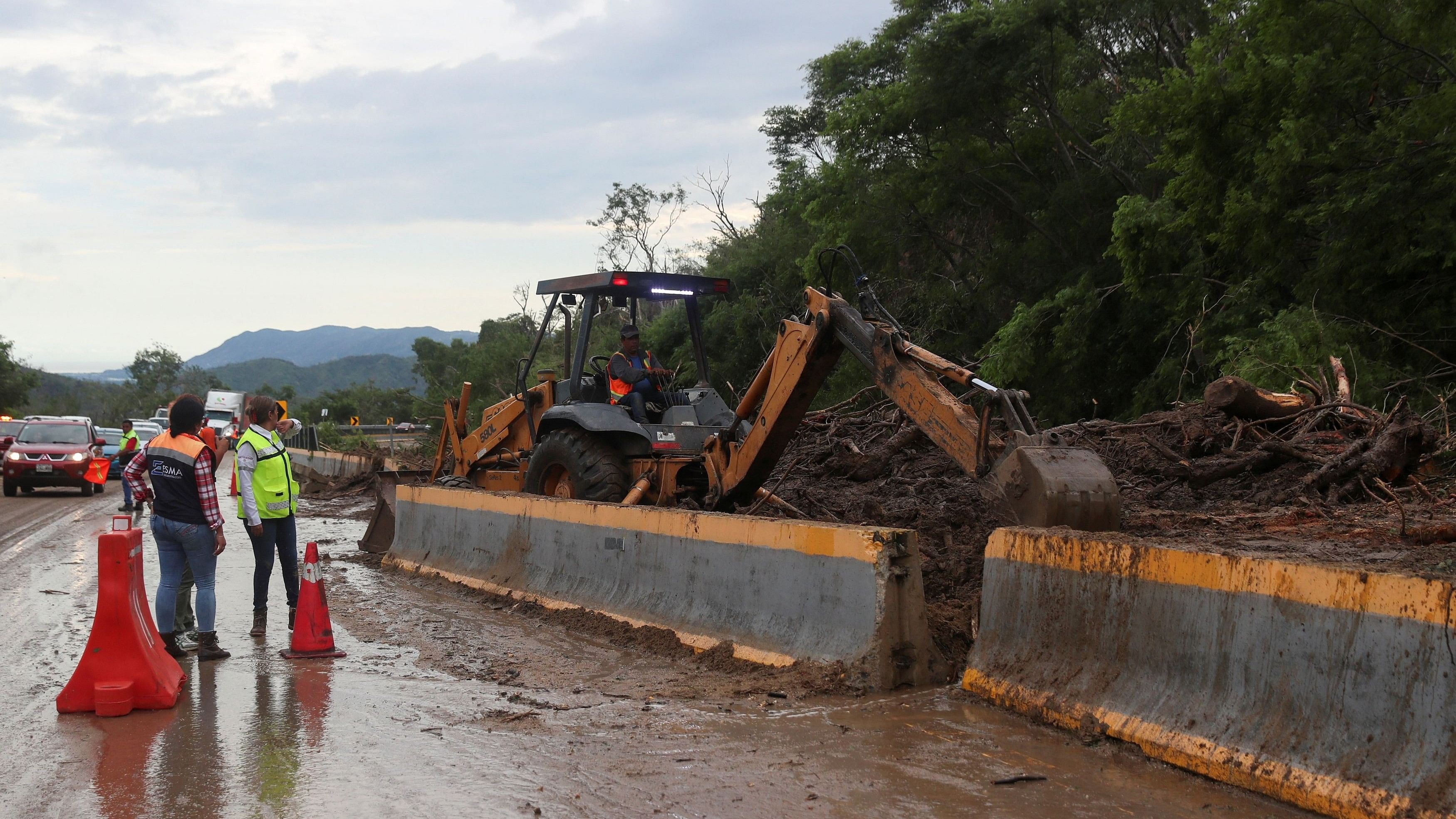 <div class="paragraphs"><p>A worker operating heavy machinery clears debris and mud left by Hurricane Otis, on a road leading to Acapulco, in the Mexican state of Guerrero.</p></div>