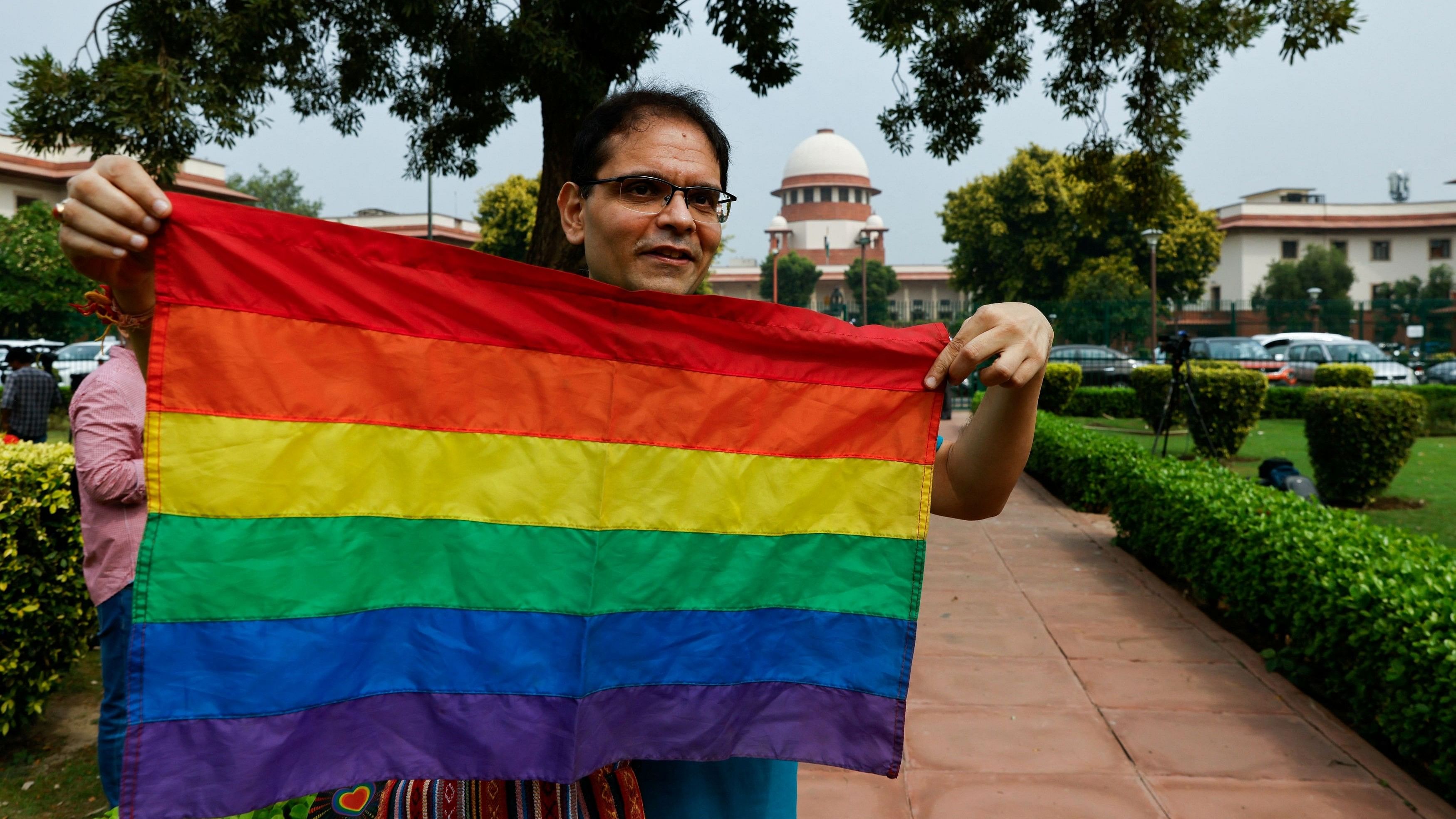 <div class="paragraphs"><p>A writer and member of the lesbian, gay, bisexual and transgender community  holds the pride flag while waiting to hear the judgement on same-sex marriage by the Supreme Court in New Delhi, India, October 17, 2023. </p></div>