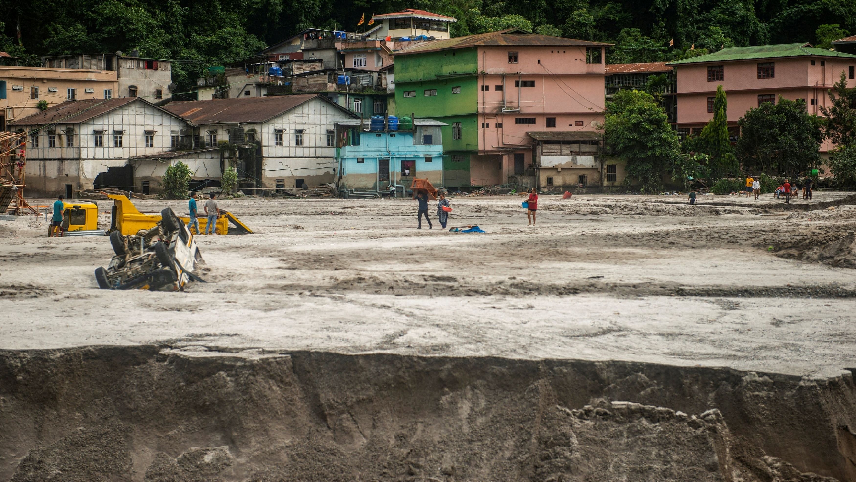 <div class="paragraphs"><p>People walk along the area affected by the flood at Golitar, in Singtam, Sikkim, India October 5, 2023. </p></div>