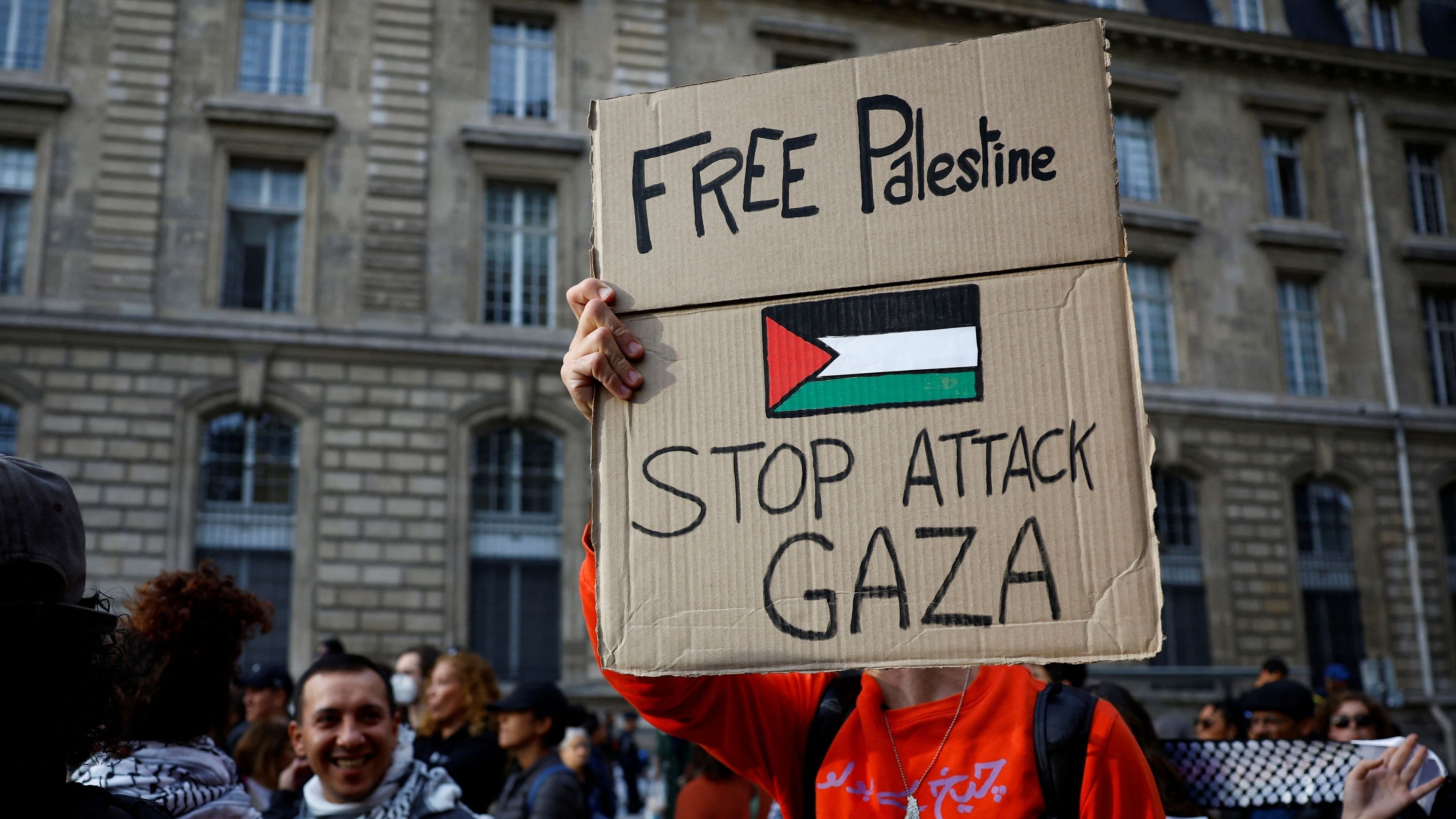 <div class="paragraphs"><p>A protestor holds a placard reading "Free Palestine.  </p></div>