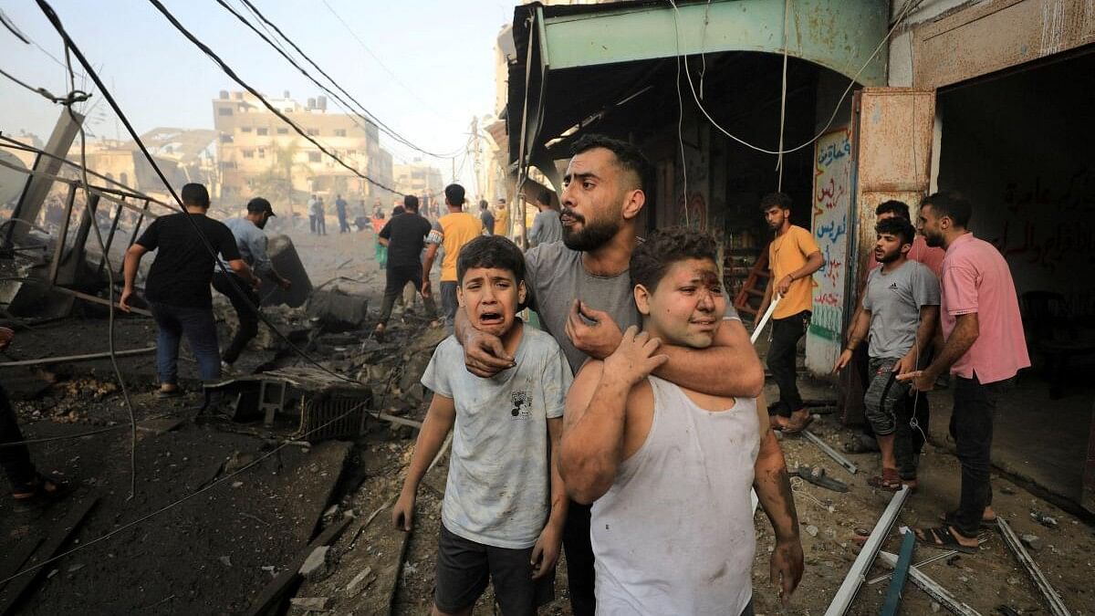 <div class="paragraphs"><p>People react as Palestinians search for casualties at the site of an Israeli strike on a residential building in Gaza City.</p></div>