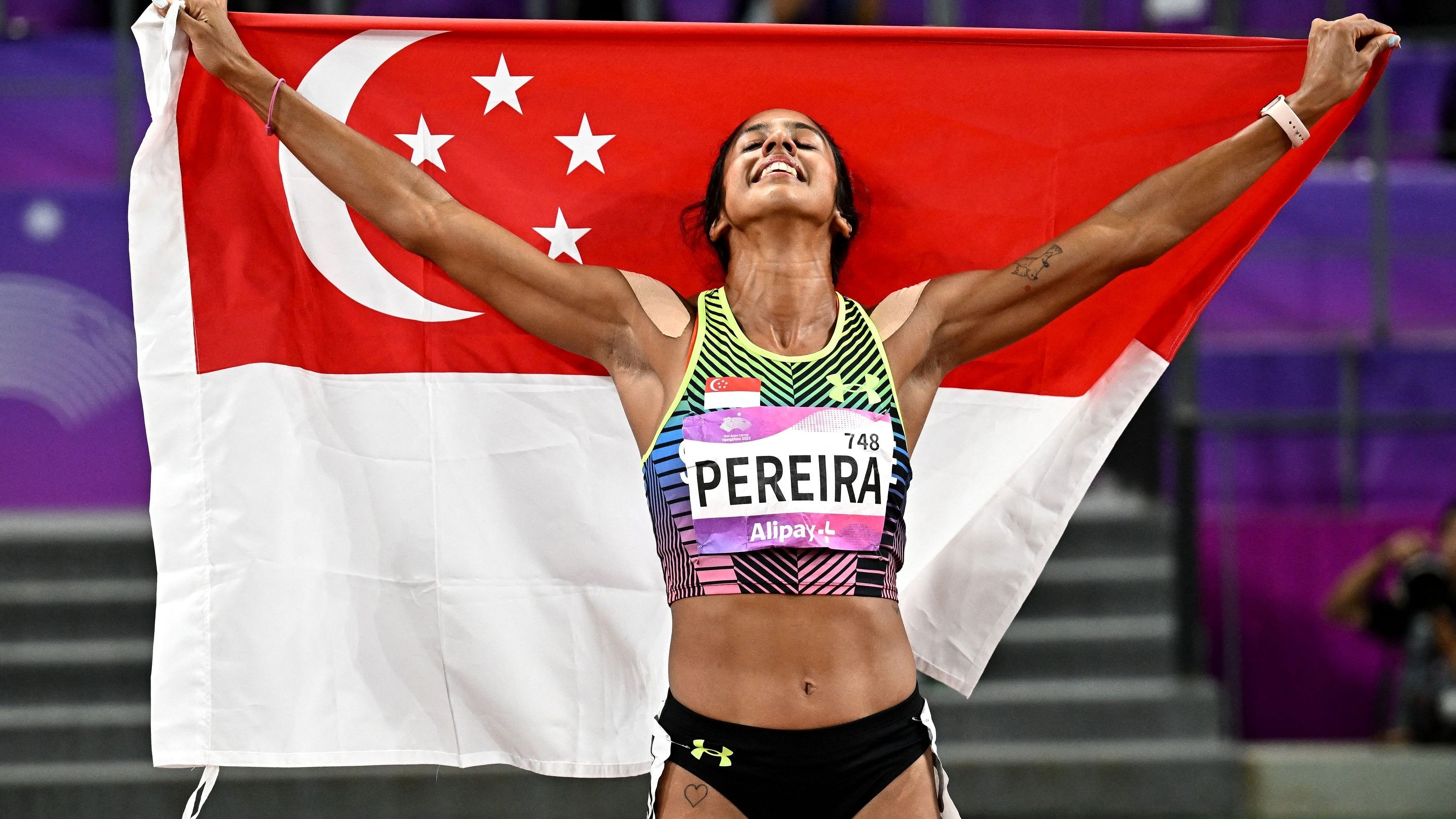 <div class="paragraphs"><p> Singapore's Veronica Shanti Pereira celebrates with the Singapore flag after winning gold in the Women's 200m Final.</p></div>