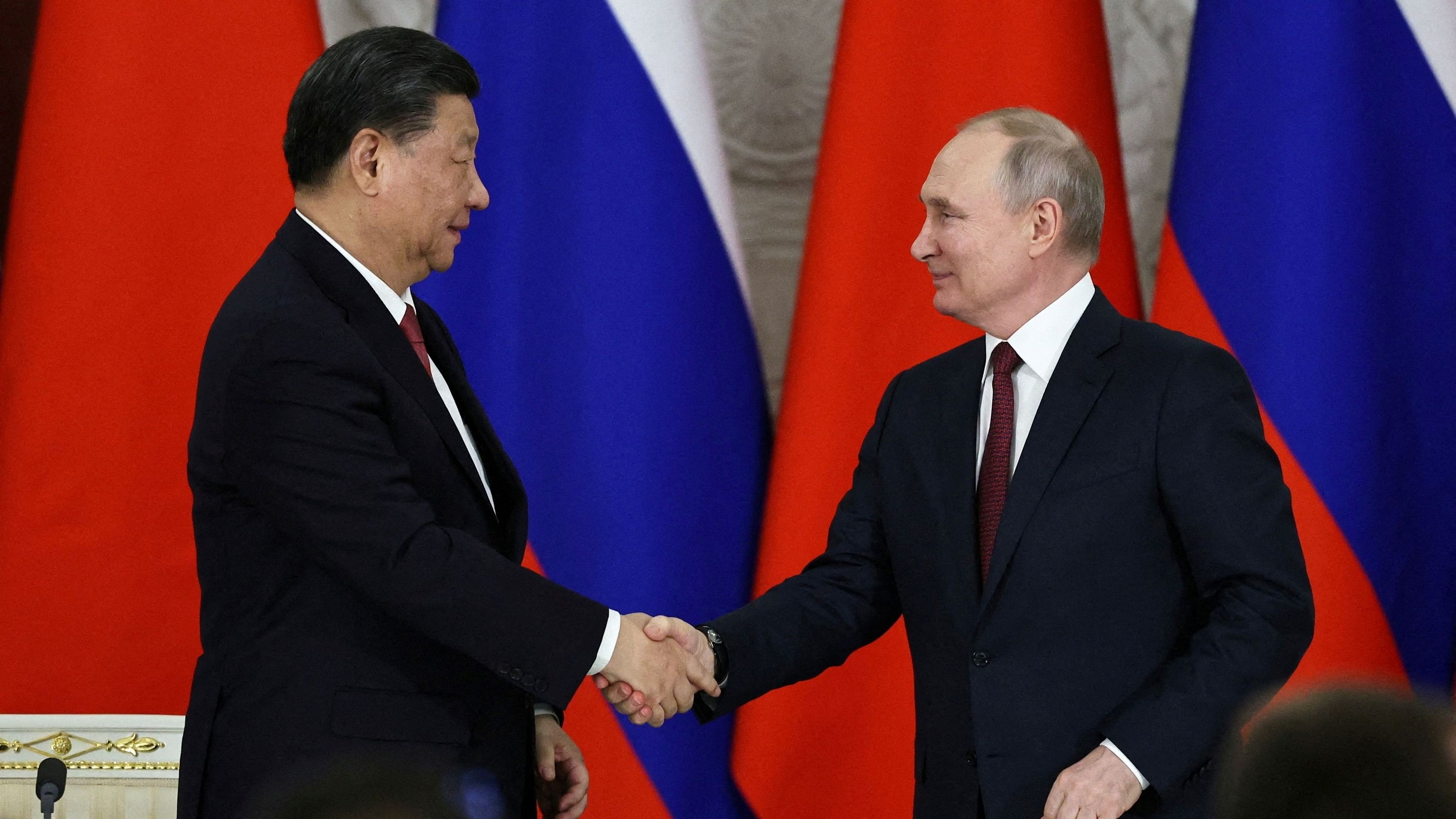 <div class="paragraphs"><p> Russian President Vladimir Putin shakes hands with Chinese President Xi Jinping   </p></div>