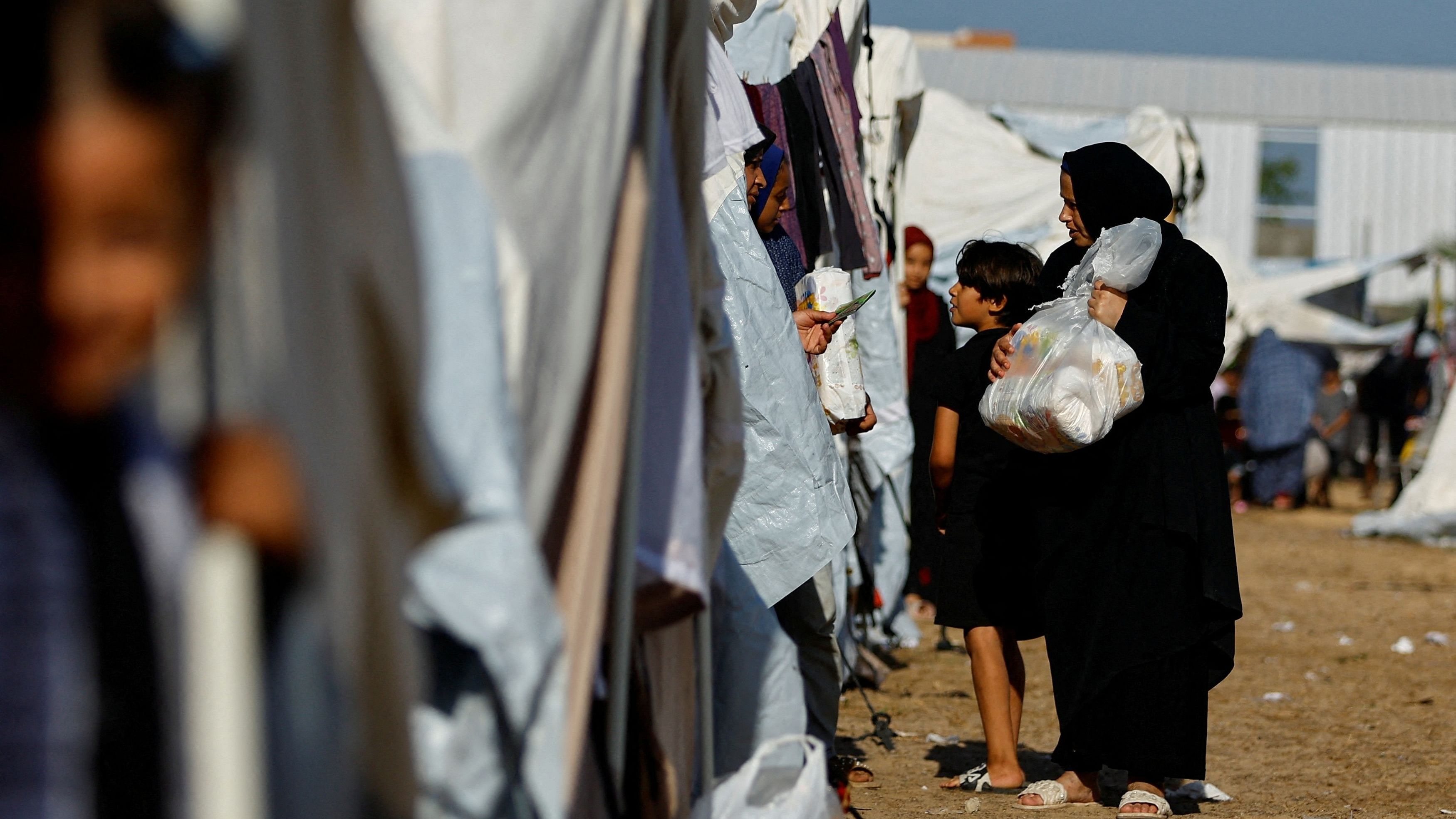 <div class="paragraphs"><p>Palestinians, who fled their houses amid Israeli strikes, take shelter at a tent camp at a United Nations-run centre, after Israel's call for more than 1 million civilians in northern Gaza to move south, in Khan Younis in the southern Gaza Strip, October 26, 2023. </p></div>