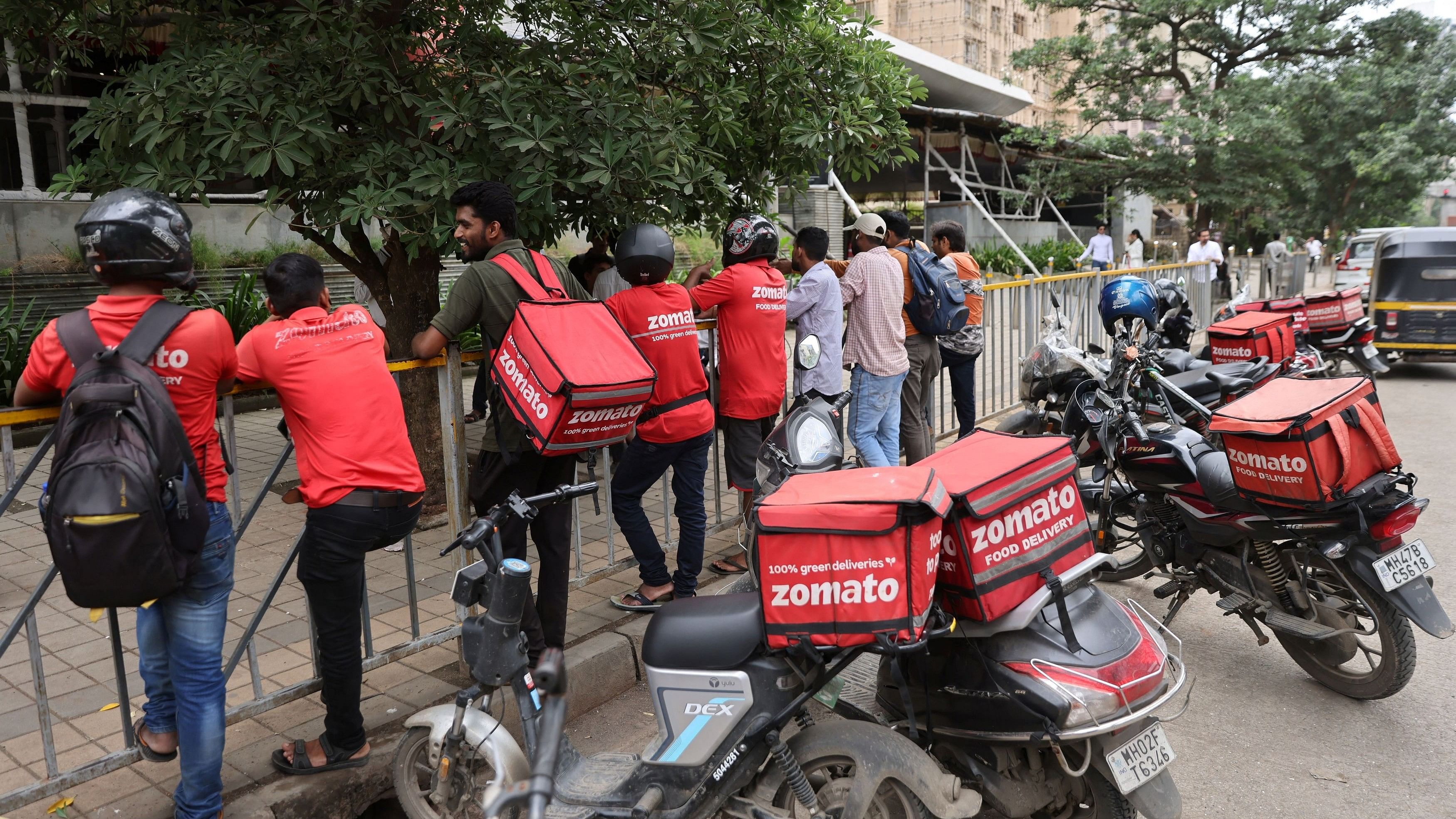 <div class="paragraphs"><p>Gig workers wait in line to collect their delivery order outside a mall.</p></div>