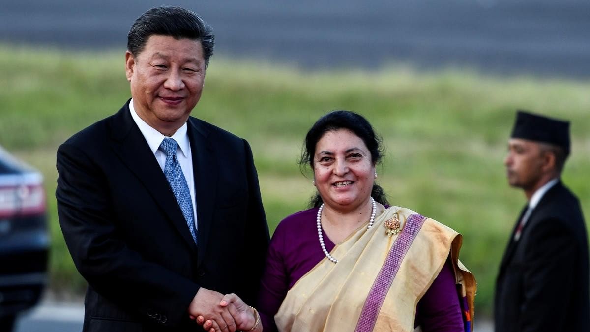 <div class="paragraphs"><p>Nepal's President Bidhya Devi Bhandari shakes hands with China's President Xi Jinping during a welcome ceremony at Tribhuvan International Airport in Kathmandu, Nepal October 12, 2019.</p></div>
