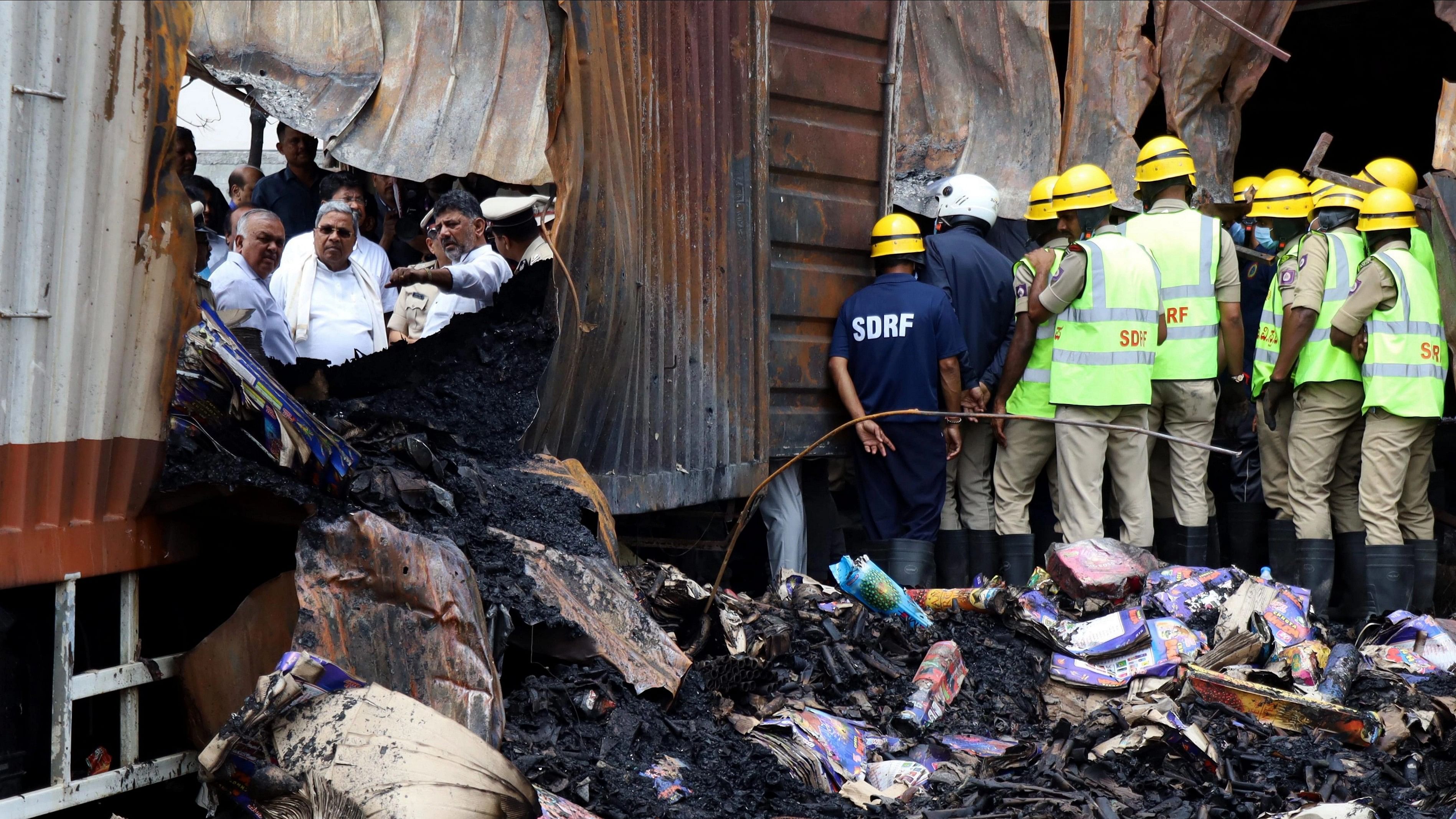 <div class="paragraphs"><p>Bengaluru: Karnataka Chief Minister Siddaramaiah with Deputy Chief Minister DK Shivakumar at the site where a firecracker shop-cum-godown caught fire on Saturday, at Attibele in Bengaluru district.</p></div>