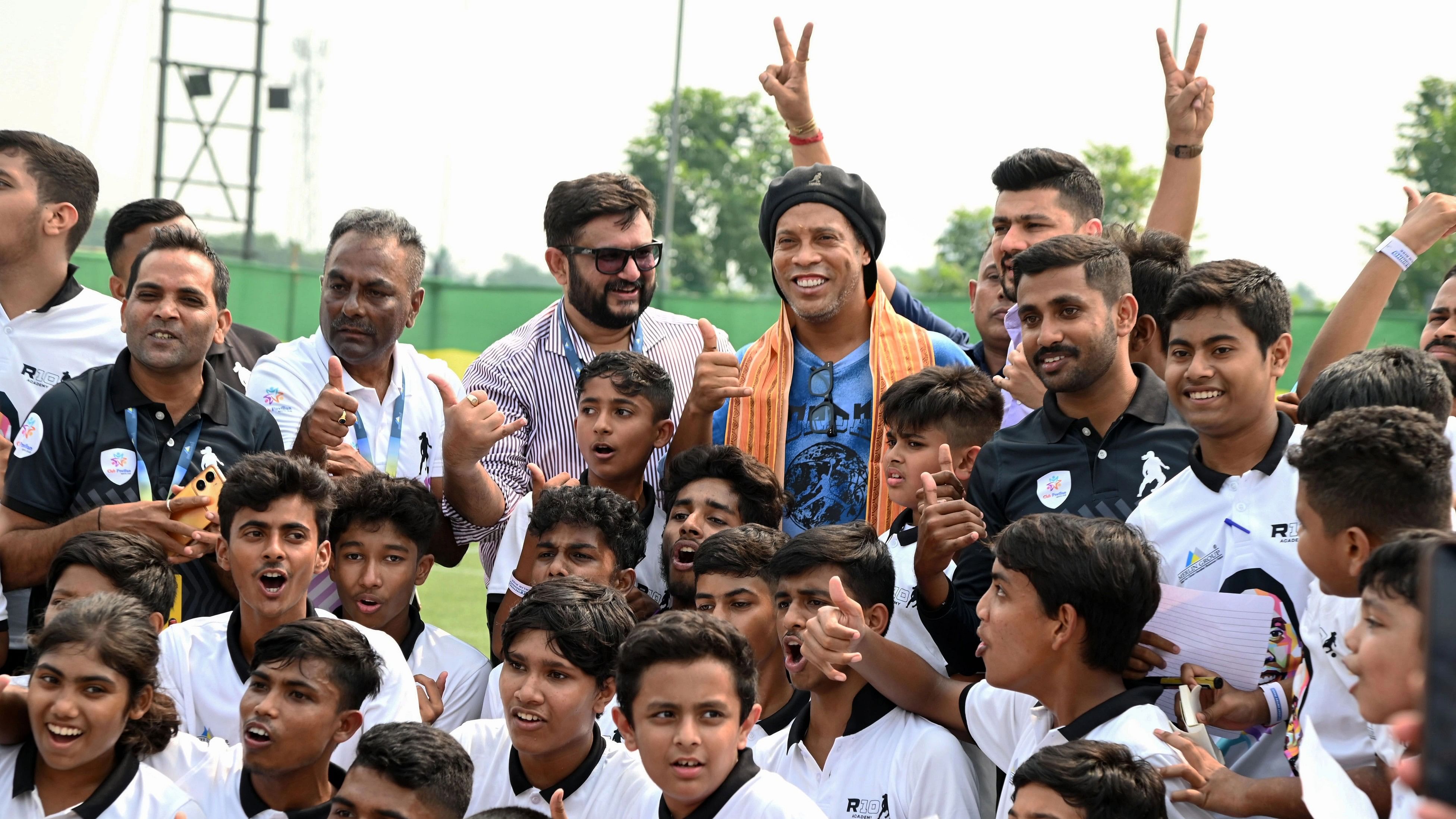 <div class="paragraphs"><p>Brazilian soccer icon Ronaldinho with aspiring footballers during the inauguration of 'R 10 Academy', at Rajarhat on the outskirts of Kolkata.</p></div>