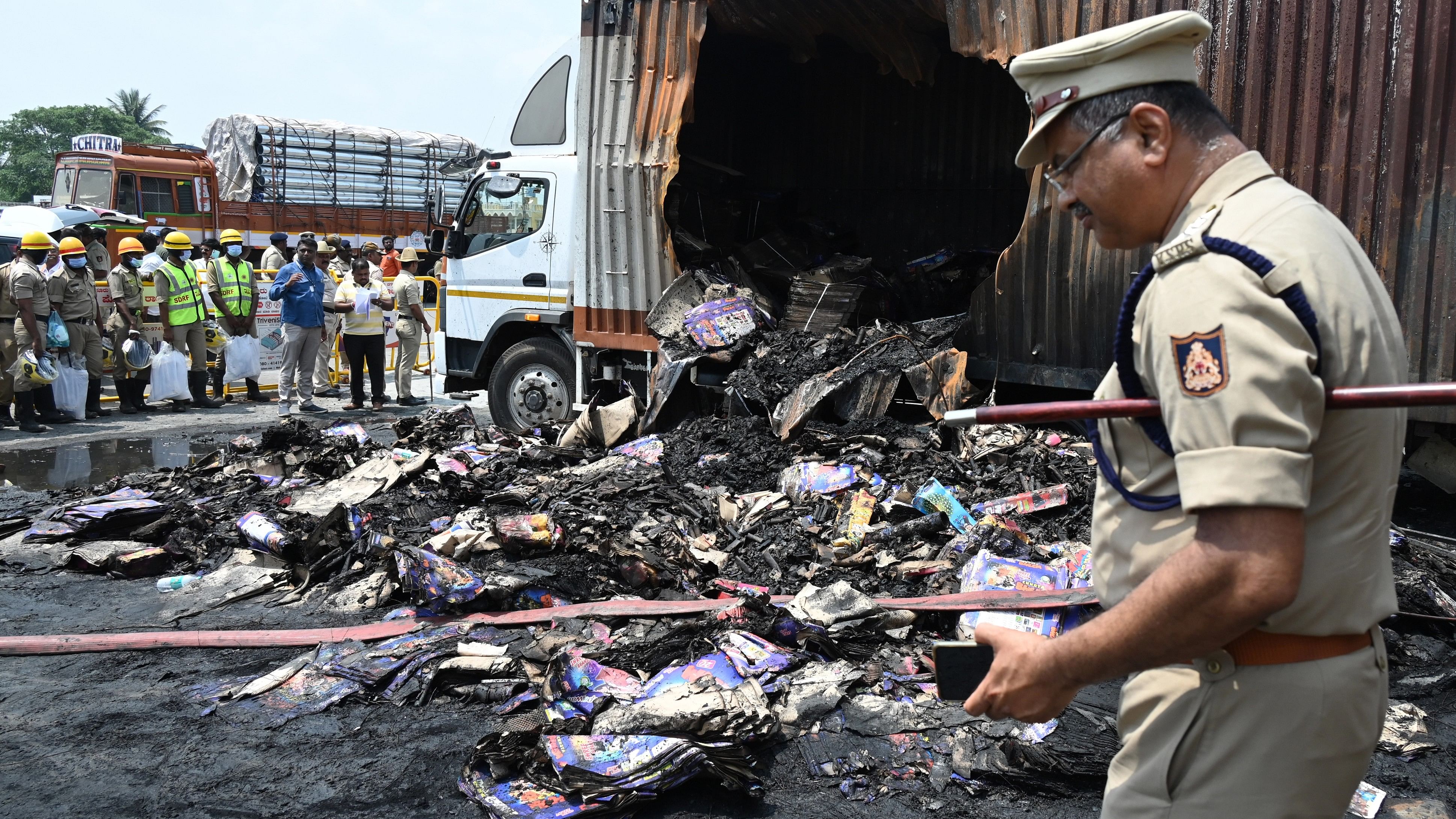 <div class="paragraphs"><p>Police at the site of the firecracker godown blaze in Attibele on Sunday. </p></div>