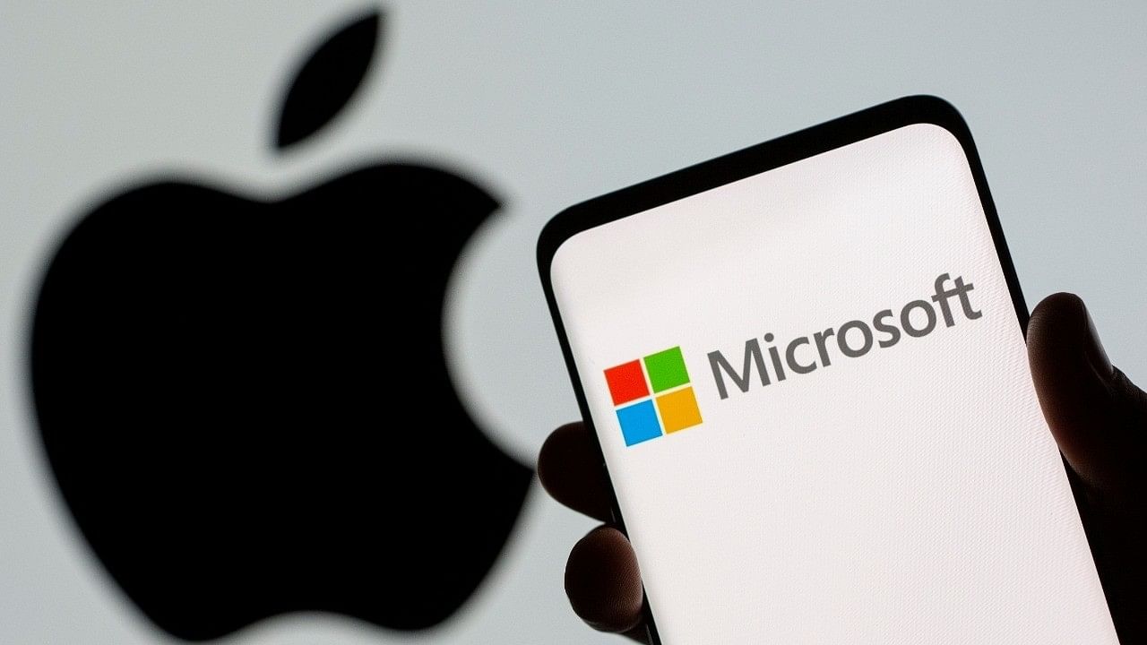 <div class="paragraphs"><p>Microsoft logo is seen on the smartphone in front of displayed Apple logo.</p></div>
