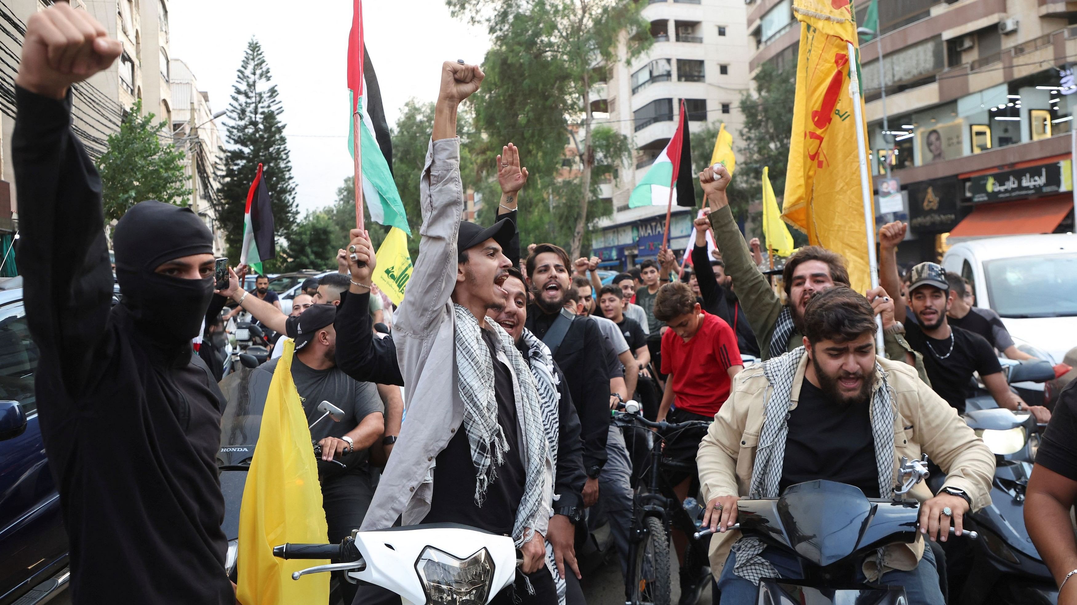 <div class="paragraphs"><p>Men chant slogans and hold flags to express solidarity with Palestinians in Gaza, in Beirut suburbs, Lebanon.&nbsp;</p></div>