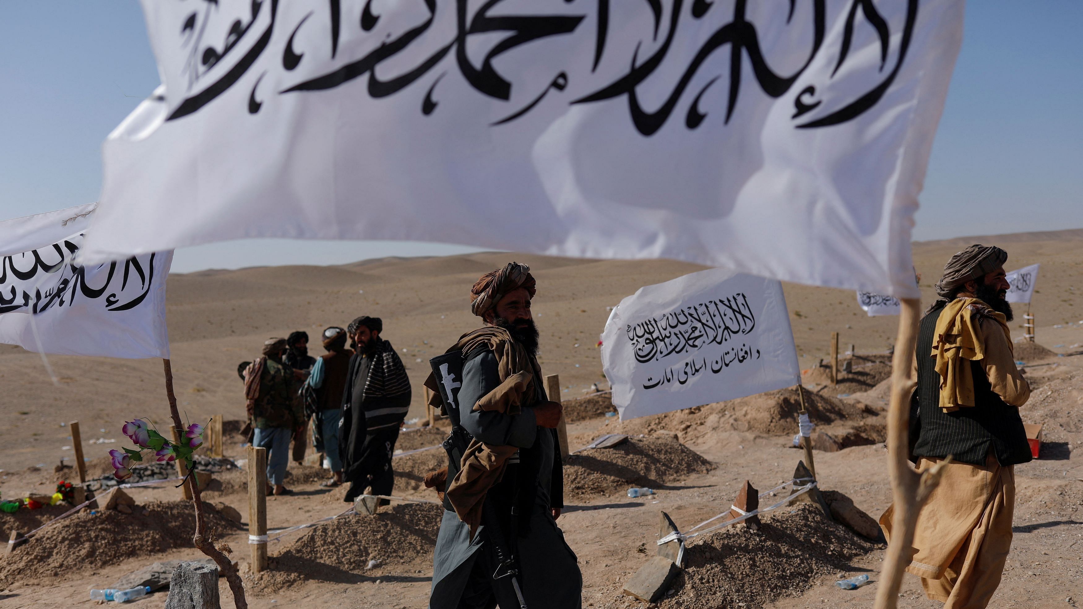 <div class="paragraphs"><p>Taliban soldiers walk in a cemetery of victims of the recent earthquake in the district of Zinda Jan, in Herat.&nbsp;</p></div>