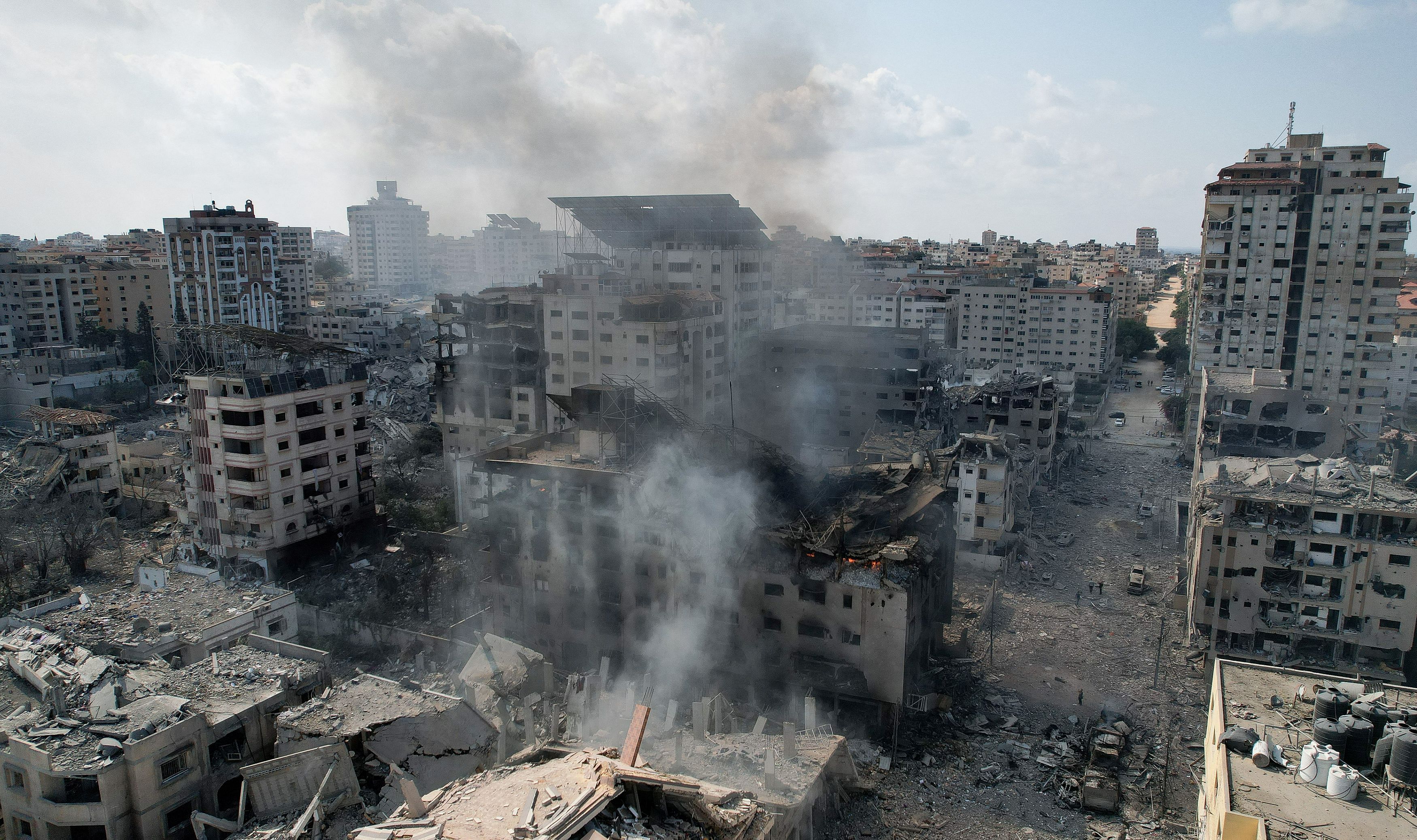 <div class="paragraphs"><p>A view shows smoke near houses and buildings destroyed by Israeli strikes in Gaza City, October 10, 2023.</p></div>