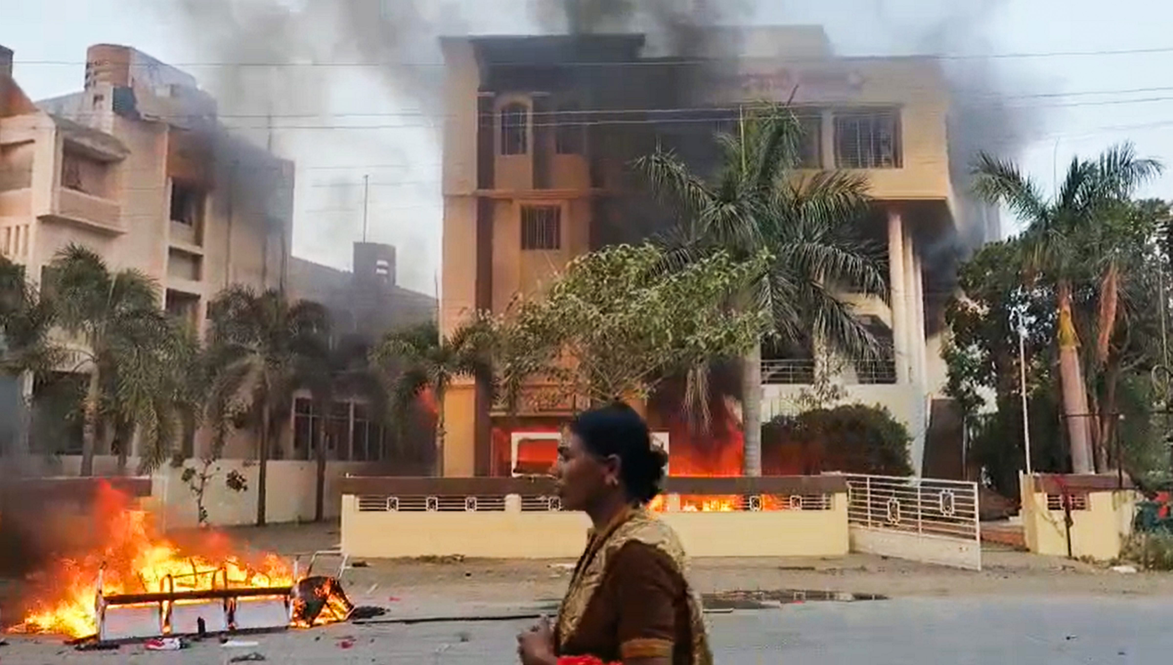 <div class="paragraphs"><p> Smoke billows after an office of NCP was set on fire by Maratha reservation agitators, in Beed district, Maharashtra, Monday, Oct. 30, 2023.</p></div>