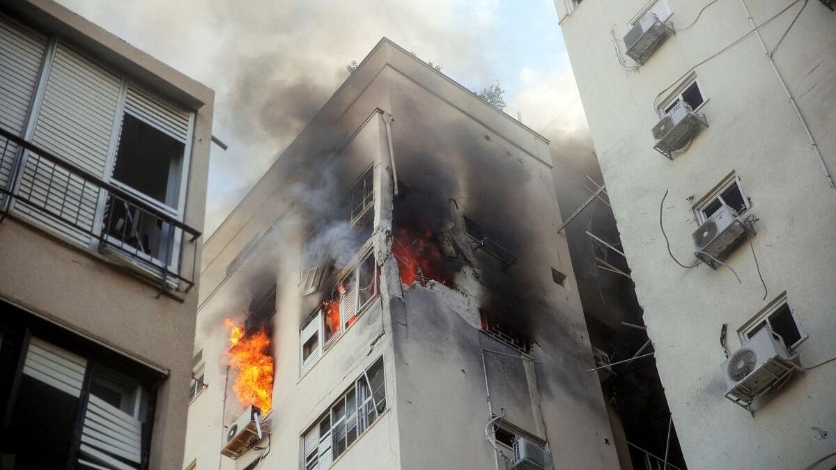 <div class="paragraphs"><p>A building is ablaze following rocket attacks from the Gaza Strip, in Tel Aviv, Israel.</p></div>