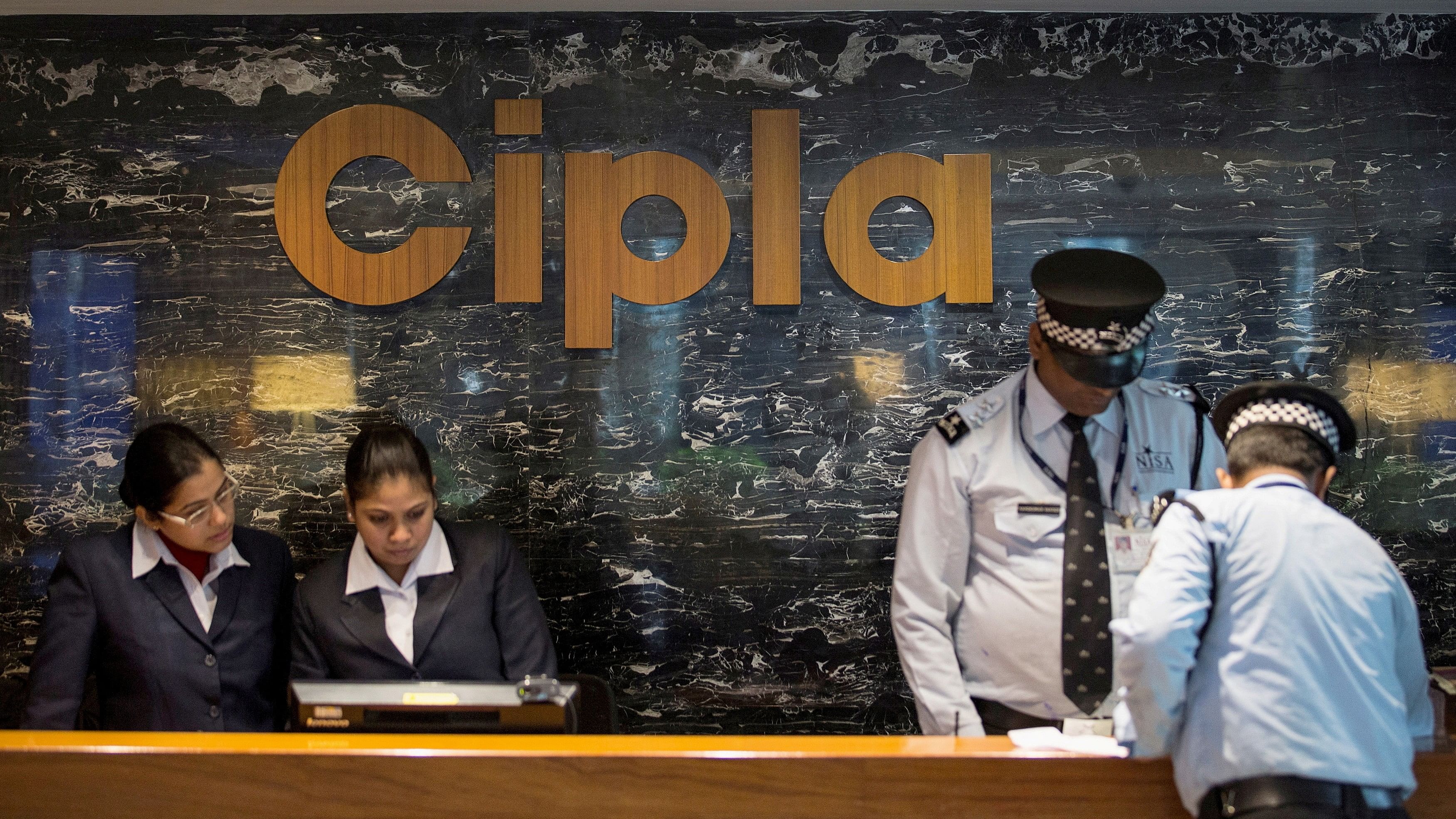 <div class="paragraphs"><p>Employees and security staff work at the reception area of Cipla at its headquarters in Mumbai.</p></div>