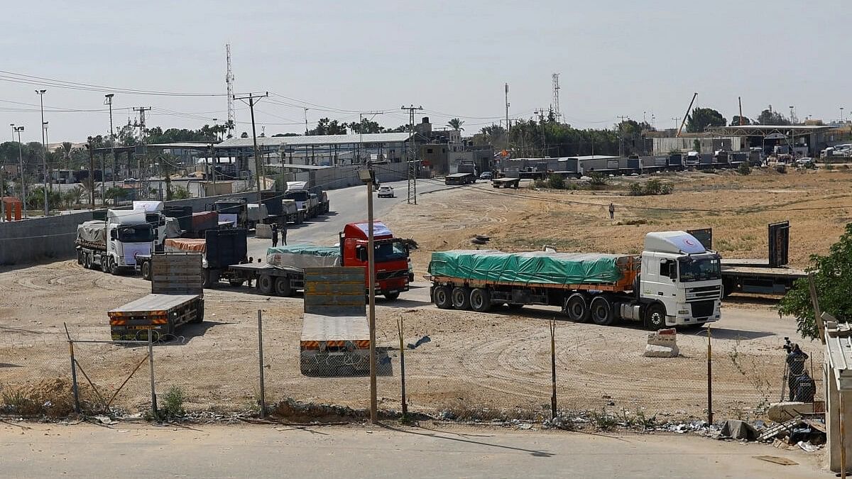 <div class="paragraphs"><p>Trucks carrying aid wait to exit, on the Palestinian side of the border with Egypt, as the conflict between Israel and Palestinian Islamist group Hamas continues, in Rafah in the southern Gaza Strip</p></div>