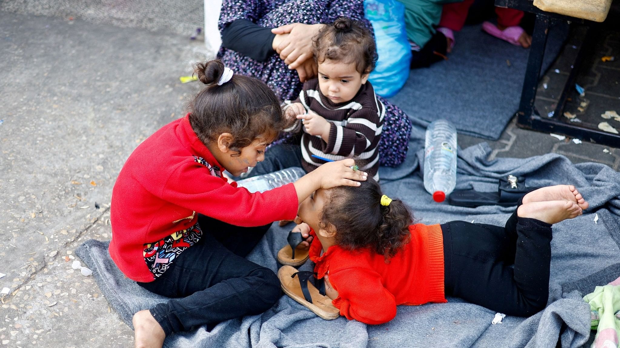 <div class="paragraphs"><p>Palestinian children, who fled their houses amid Israeli strikes, take shelter in a United Nations-run school, after Israel's call for more than 1 million civilians in northern Gaza to move south, in Khan Younis in the southern Gaza Strip.</p></div>