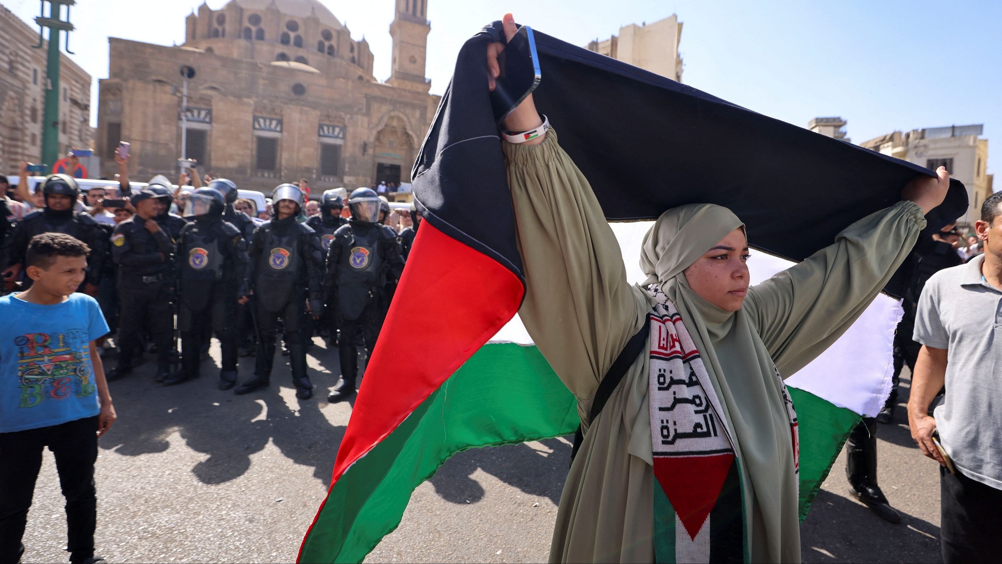 <div class="paragraphs"><p>A woman holds a Palestinian flag as people take part in a protest in support of Palestinians, amid the ongoing conflict between Israel and Palestinian Islamist group Hamas.</p></div>