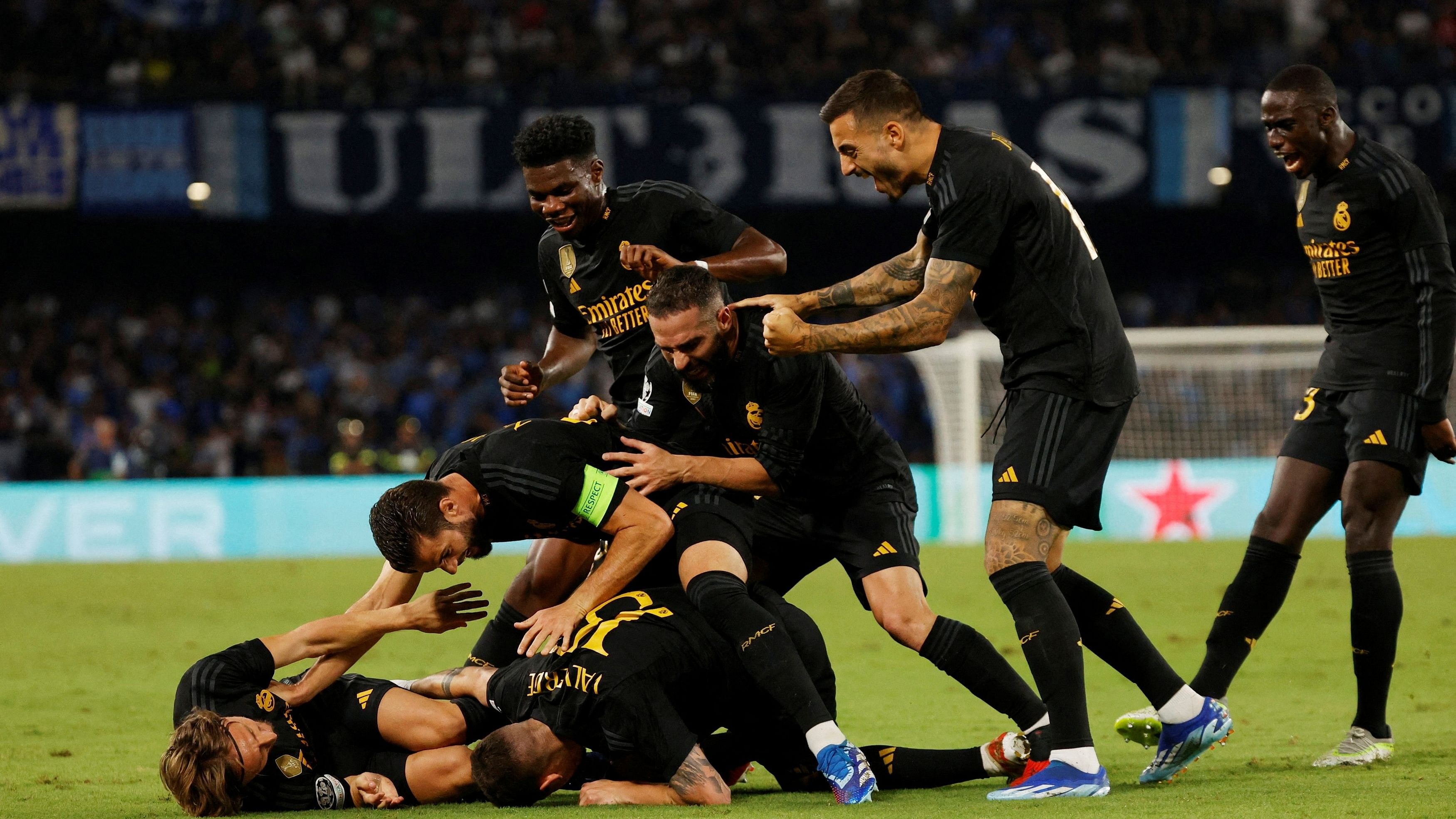 <div class="paragraphs"><p>Real Madrid players celebrate after Napoli's Alex Meret scores an own goal and the third for Real Madrid.</p></div>