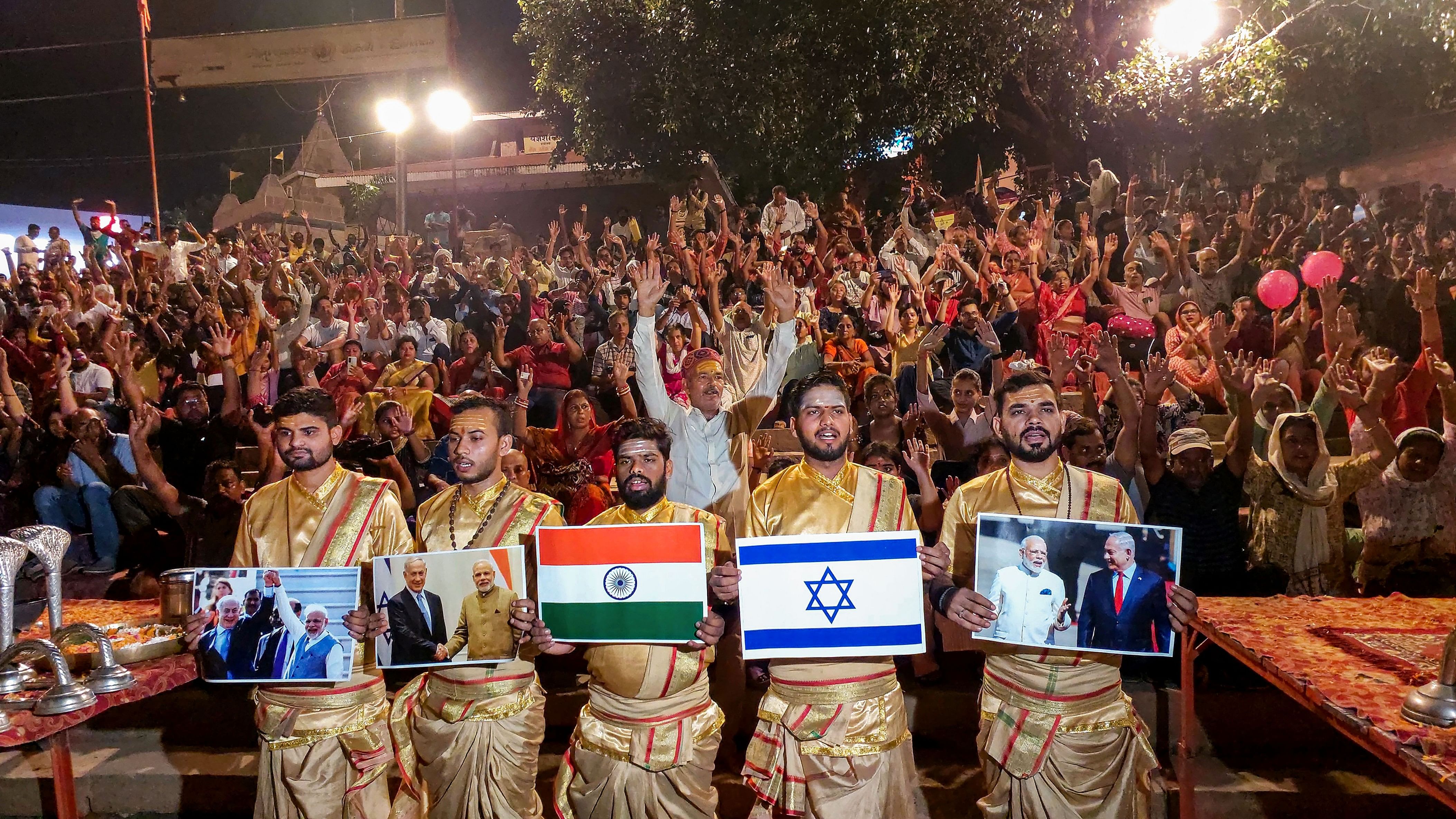 <div class="paragraphs"><p>Priests hold pictures in support of Israel during the Ganga Aarti at Assi Ghat, in Varanasi.</p></div>