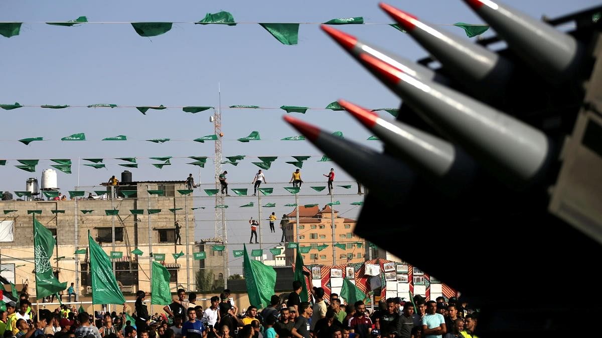 <div class="paragraphs"><p>Palestinian Hamas supporters attend an anti-Israel rally as rockets are displayed on a truck by Hamas militants in Rafah, in the southern Gaza Strip.</p></div>