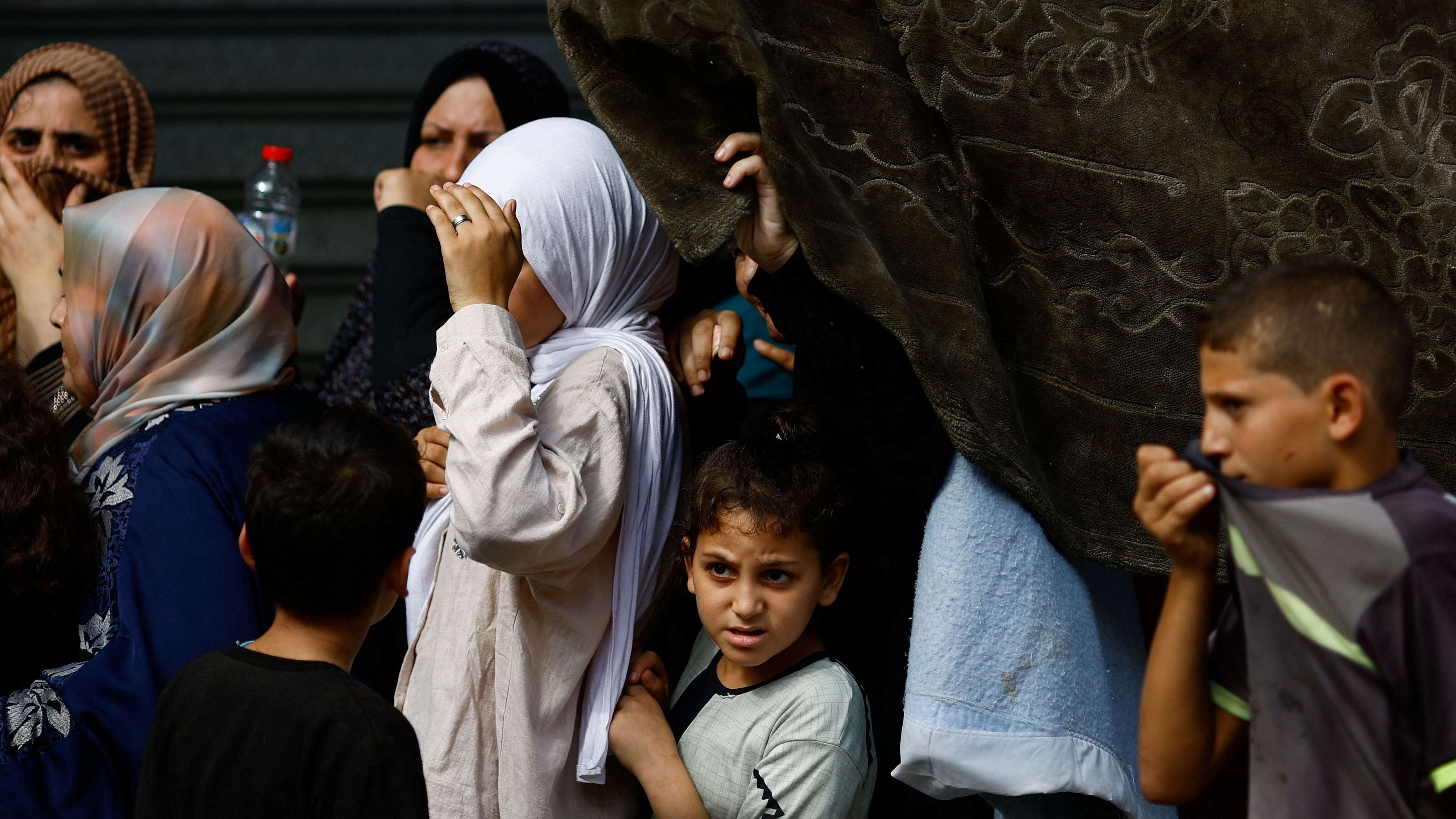 <div class="paragraphs"><p>Palestinians queue as they wait to buy bread from a bakery, amid shortages of food supplies and fuel, as the conflict between Israel and Palestinian Islamist group Hamas continues, in Khan Younis in the southern Gaza Strip.</p></div>