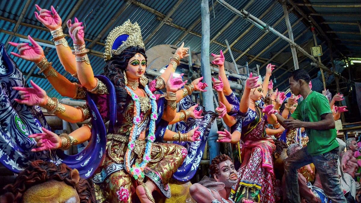 <div class="paragraphs"><p>An artist gives finishing touches to the idols of deities ahead of Durga Puja festival, in Ranchi.&nbsp;</p></div>