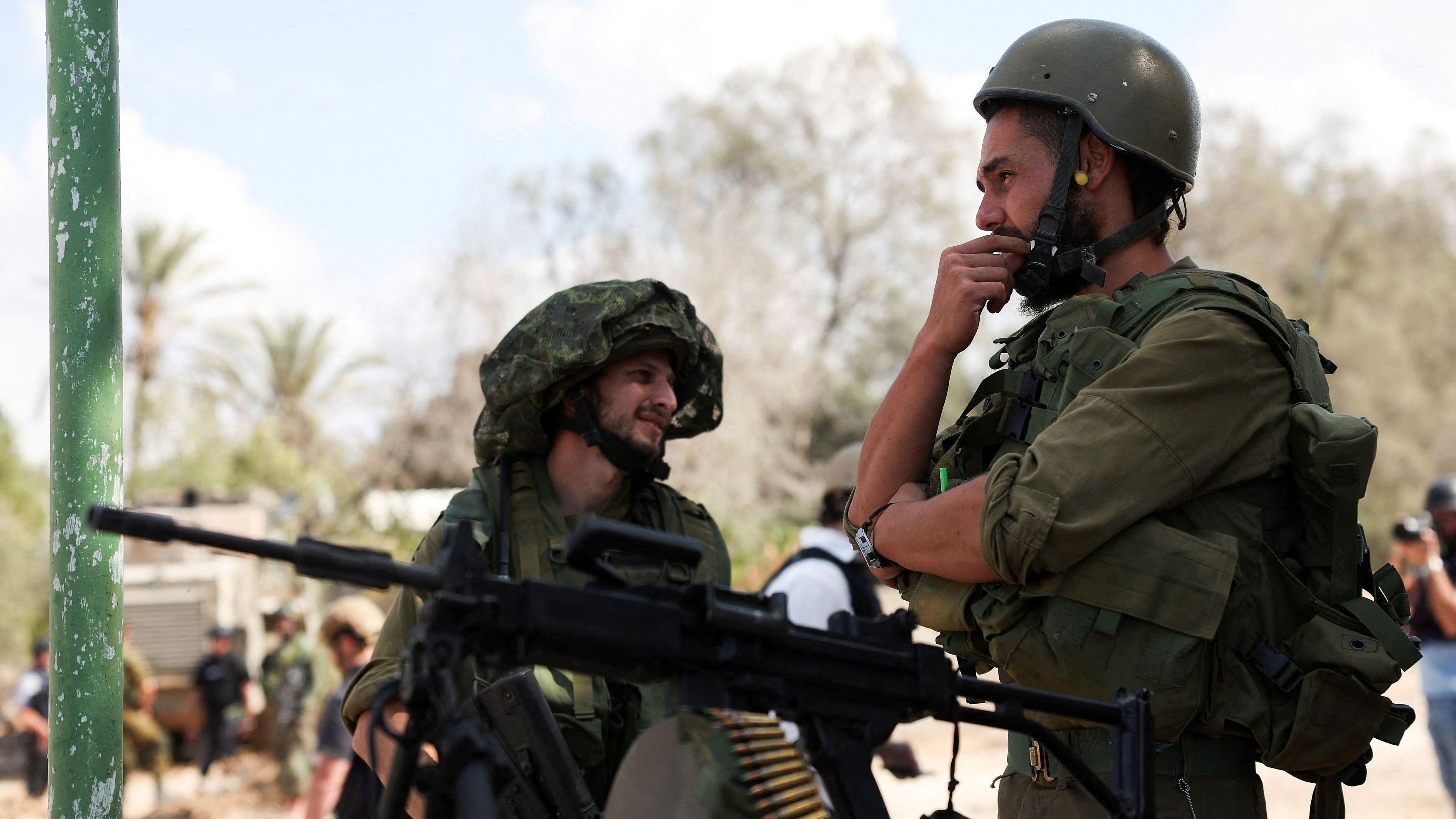 <div class="paragraphs"><p>Members of the Israeli Defense Forces stand guard, following a deadly infiltration by Hamas gunmen from the Gaza Strip.</p></div>