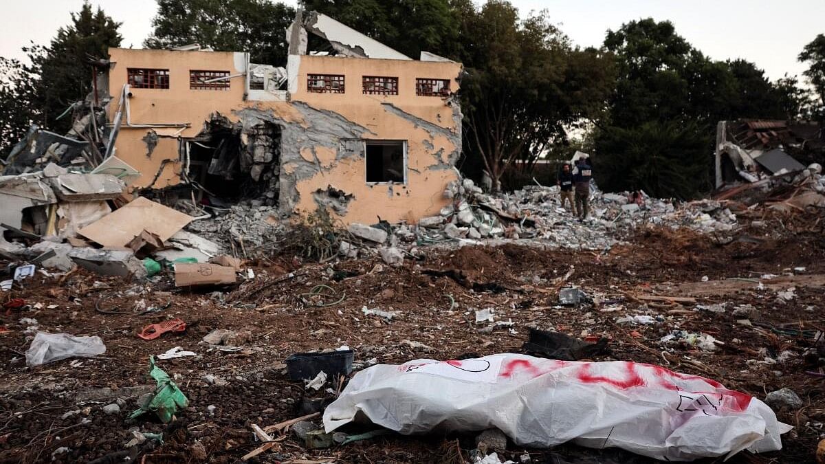 <div class="paragraphs"><p>A dead body lies on the ground following a mass infiltration by Hamas gunmen from the Gaza Strip, in Kibbutz Beeri in southern Israel.</p></div>