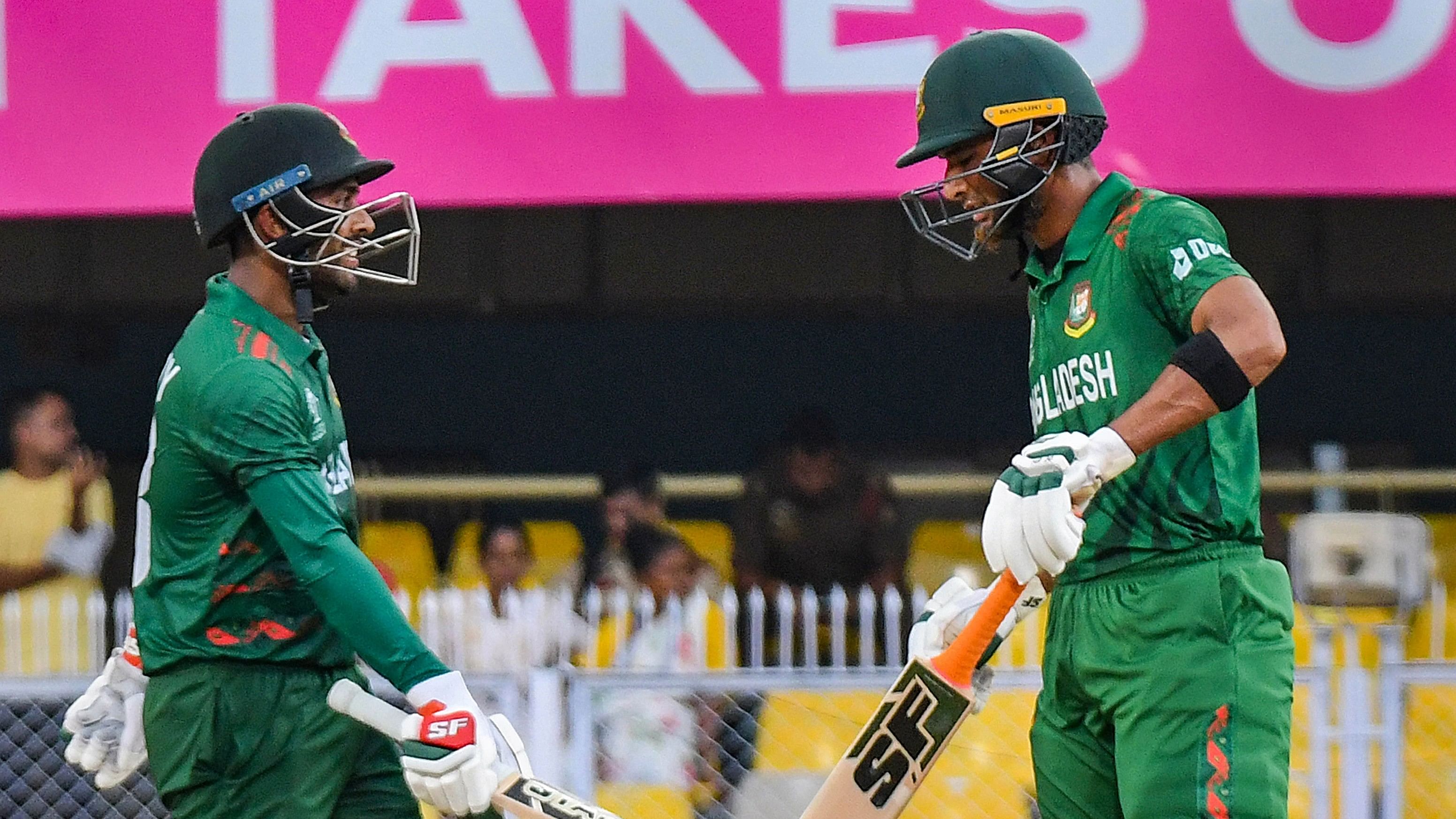 <div class="paragraphs"><p>Bangladesh's batter Mehidy Hasan Miraz (L) being congratulated by teammate Mahmudullah after his half-century during the ICC Men's Cricket World Cup 2023 warm-up match between England and Bangladesh, at Assam Cricket Association Stadium in Guwahati.</p></div>