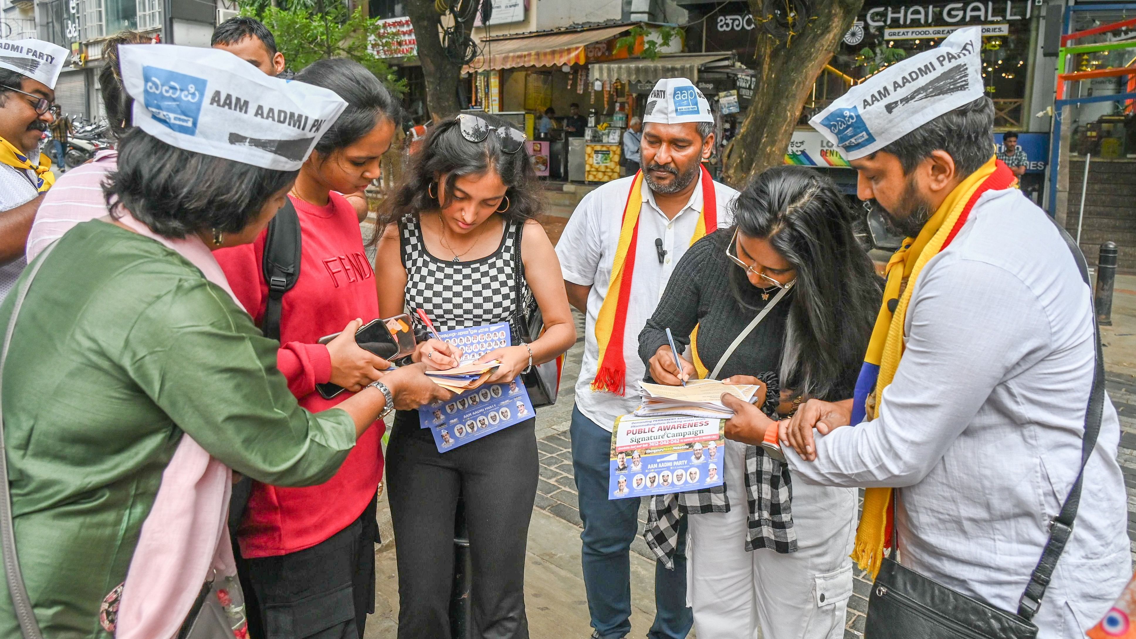 <div class="paragraphs"><p>AAP workers interact with citizens as part of an awareness campaign on Church Street on Monday.</p></div>