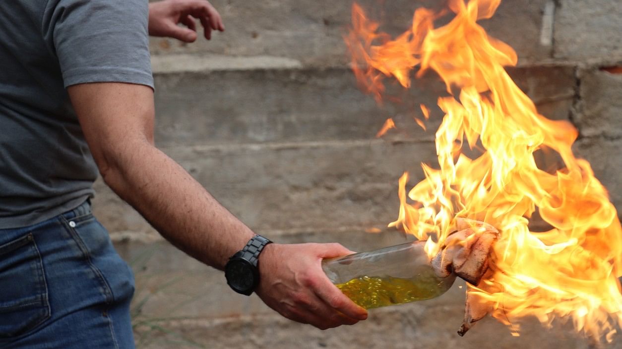 <div class="paragraphs"><p>Representative image showing a man about to throw a Molotov cocktail.</p></div>