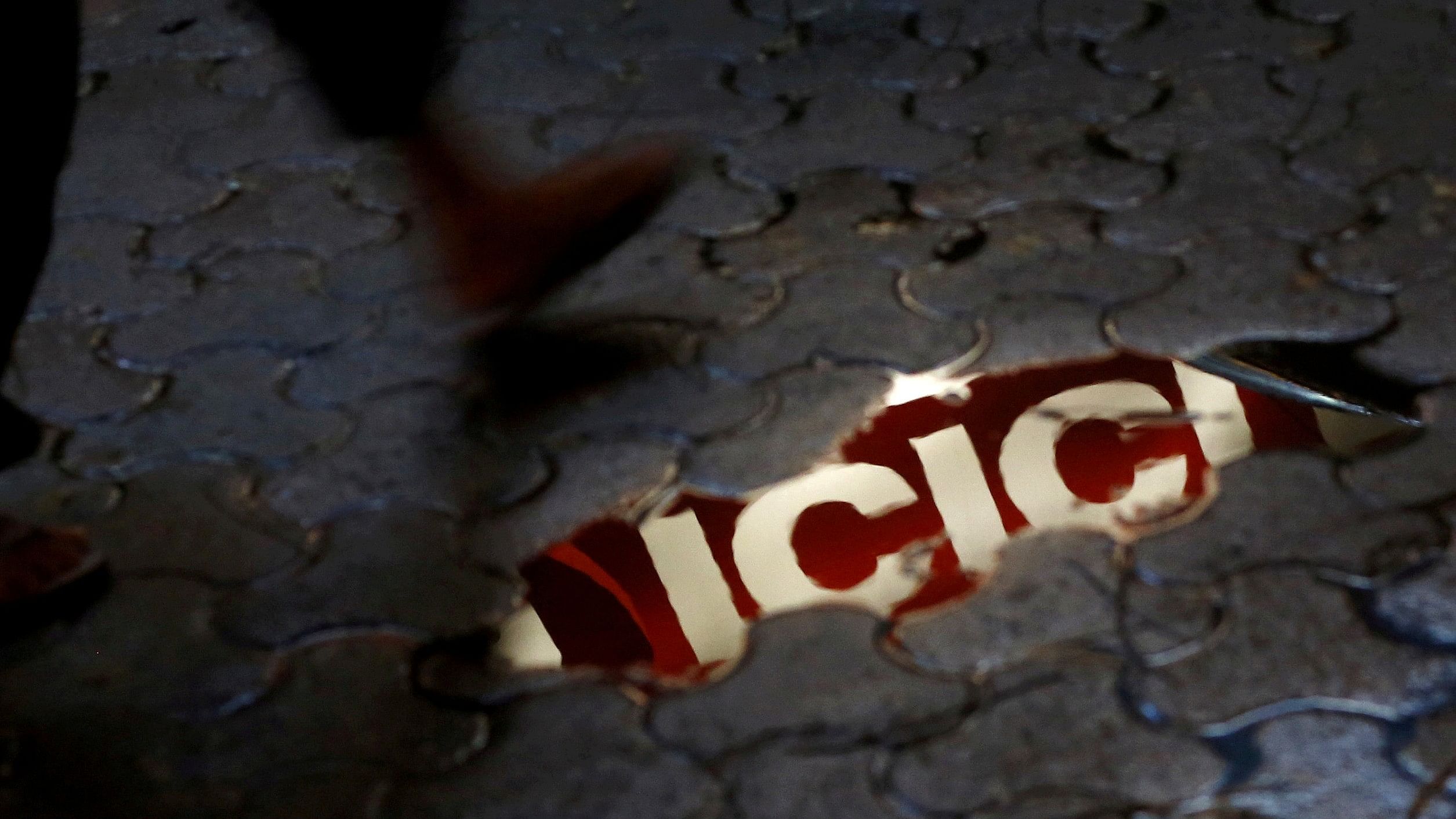 <div class="paragraphs"><p>ICICI signboard is reflected in a puddle.</p></div>