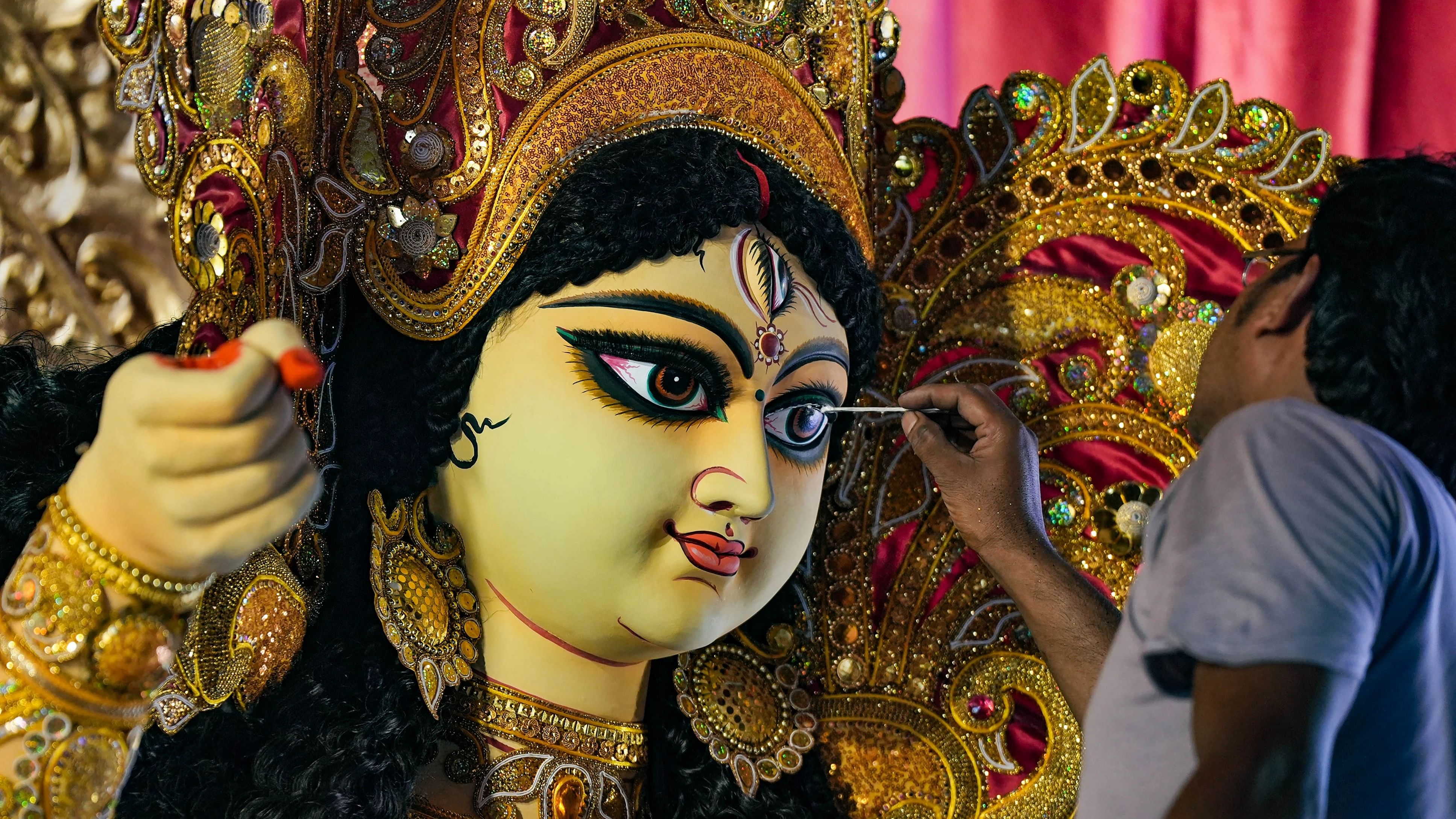 <div class="paragraphs"><p> An artist gives final touches to the idol of Goddess Durga at a pandal ahead of Durga Puja festival, in Kolkata.</p></div>