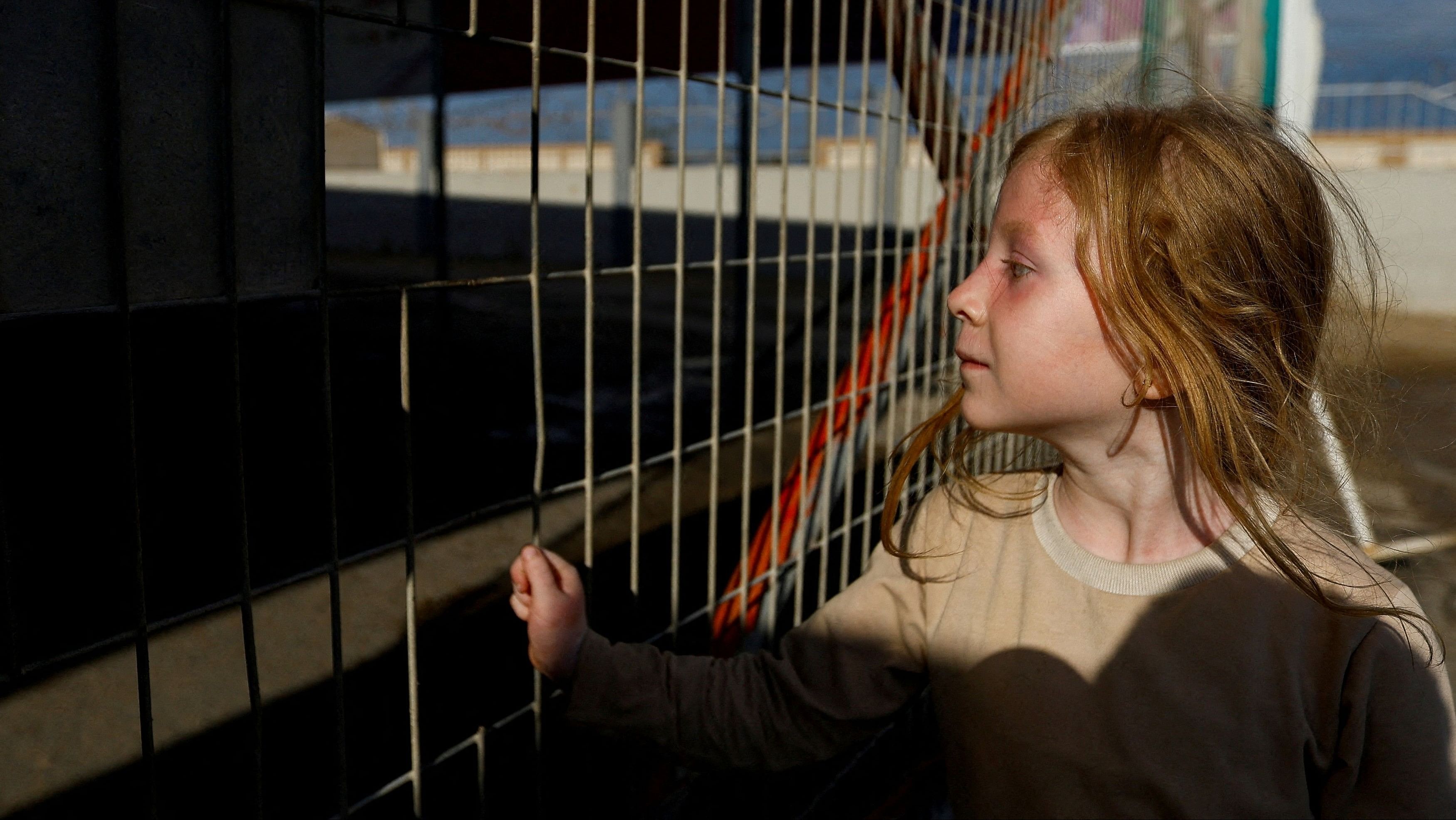 <div class="paragraphs"><p>A Palestinian girl with dual citizenship waits outside the Rafah border crossing with Egypt in the hope of getting permission to leave Gaza, amid the ongoing Israeli-Palestinian conflict, in Rafah in the southern Gaza Strip on October 17, 2023. </p></div>