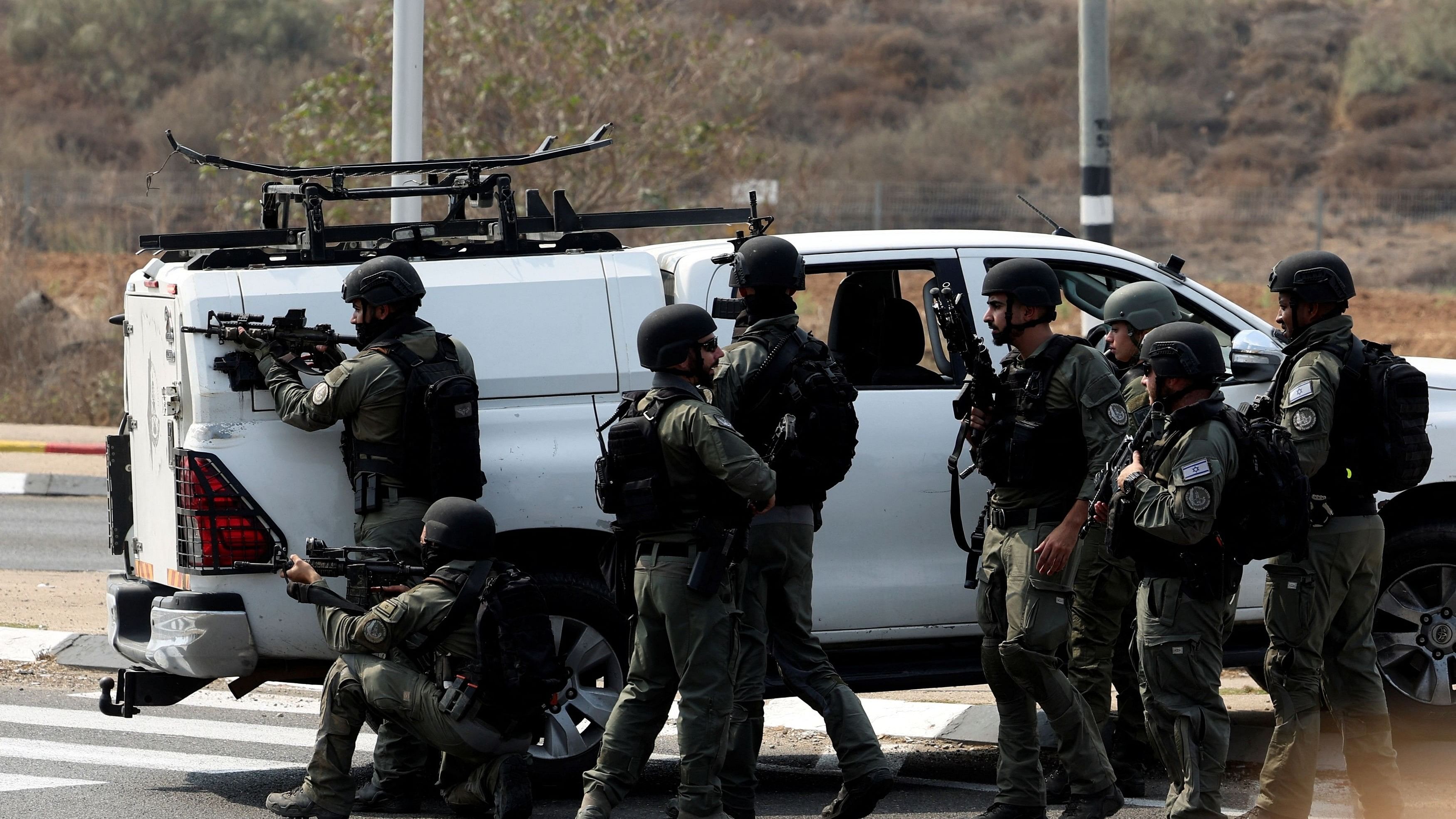 <div class="paragraphs"><p>Israeli security take position on a road following a mass infiltration by Hamas gunmen from the Gaza Strip, near Sderot in southern Israel.</p></div>