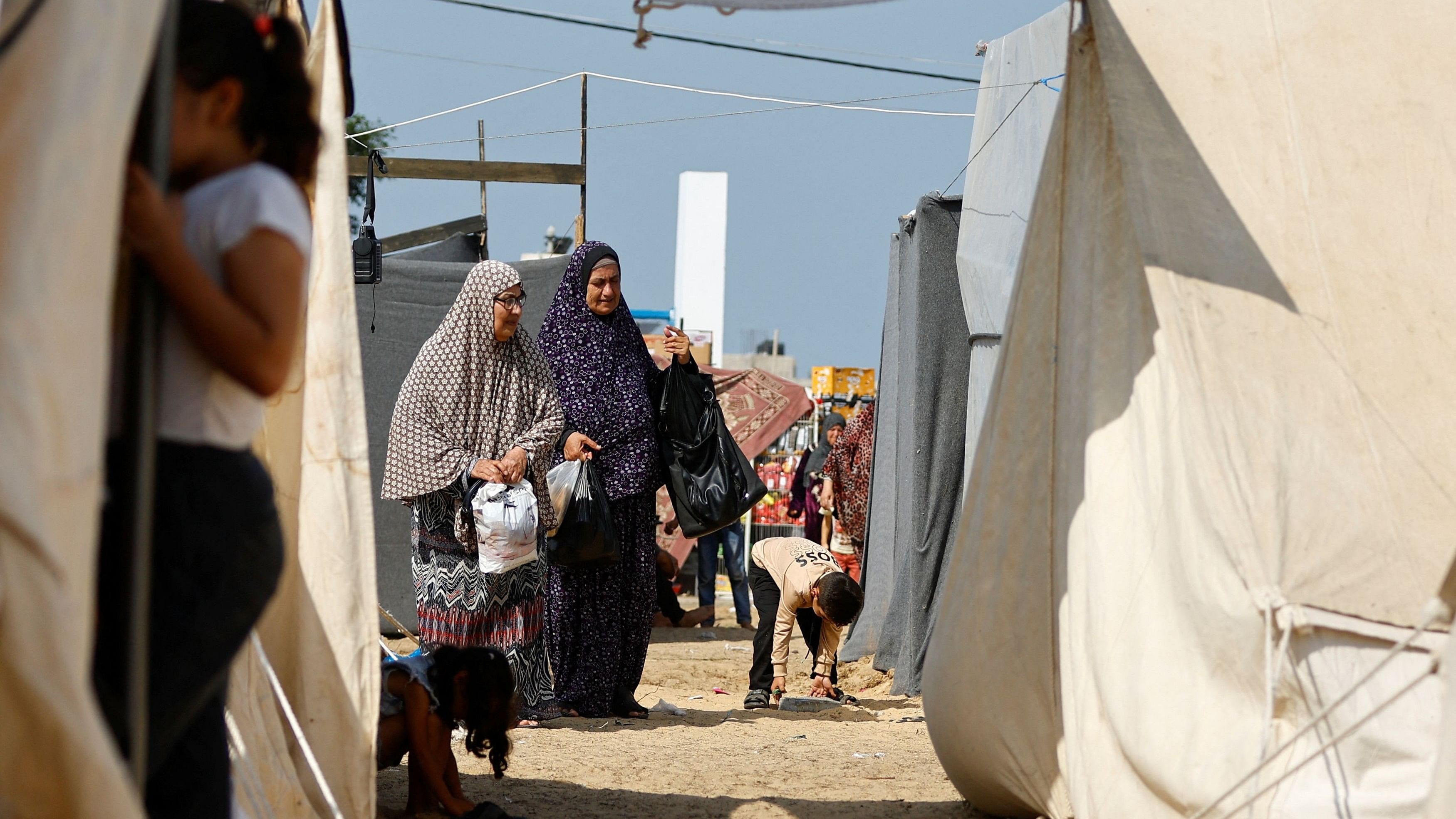 <div class="paragraphs"><p>Palestinians, who fled their houses amid Israeli strikes, take shelter in a tent camp at a United Nations-run centre, after Israel's call for more than 1 million civilians in northern Gaza to move south, in Khan Younis in the southern Gaza Strip, October 23, 2023. </p></div>