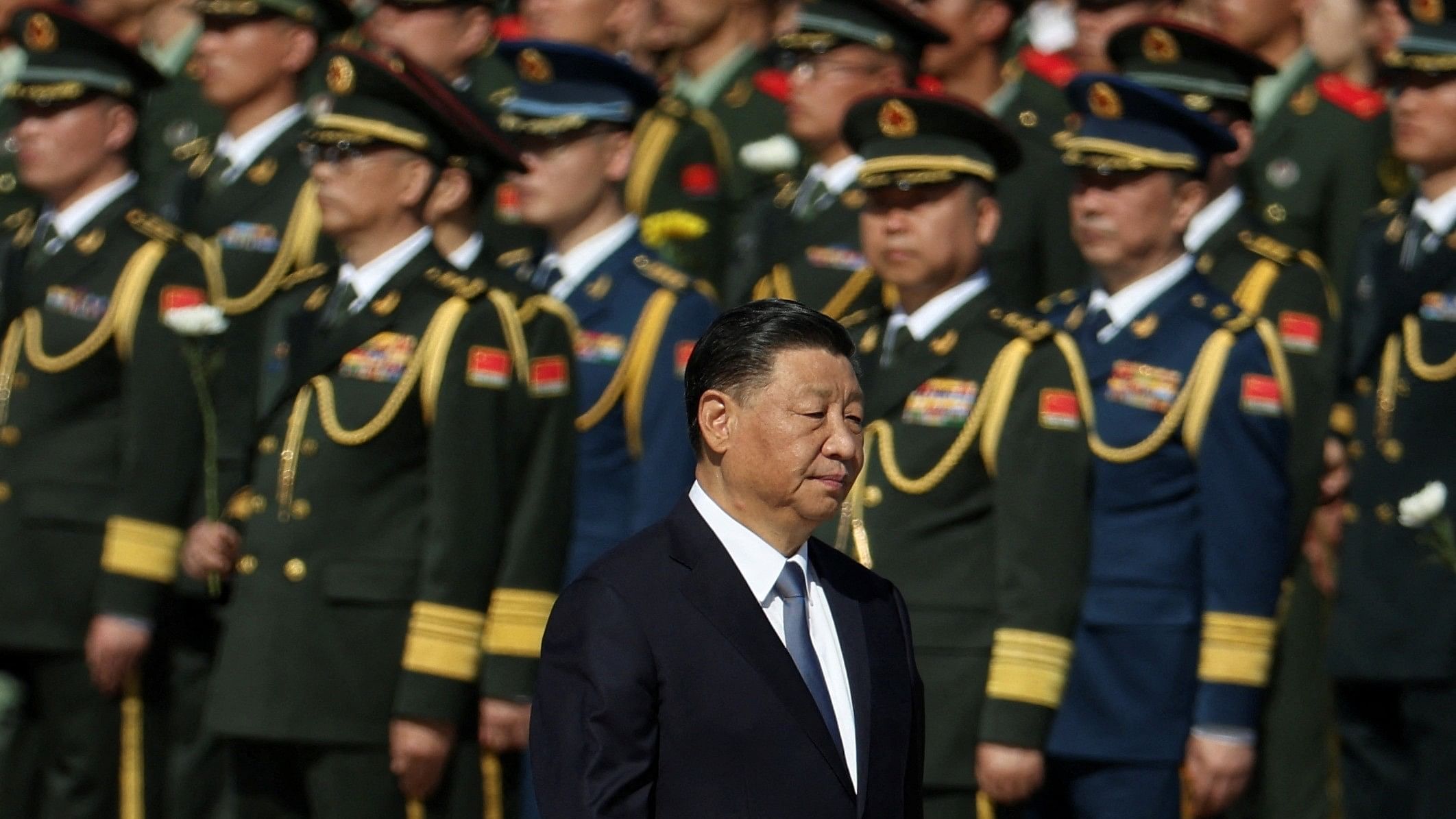 <div class="paragraphs"><p>Chinese President Xi Jinping walks past members of the Chinese People's Liberation Army.</p></div>