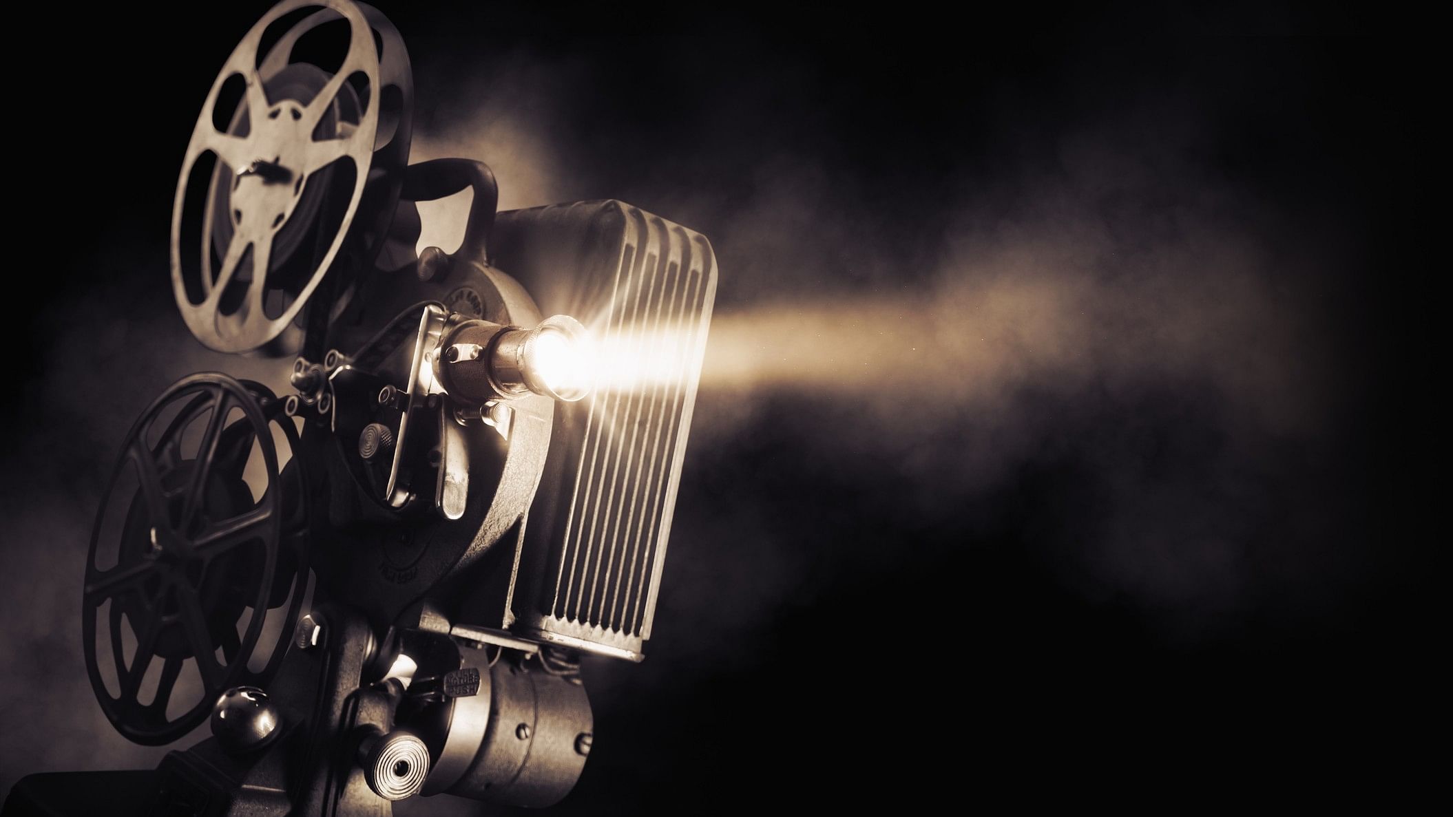 <div class="paragraphs"><p>Movie projector on a dark background with light beam.</p></div>