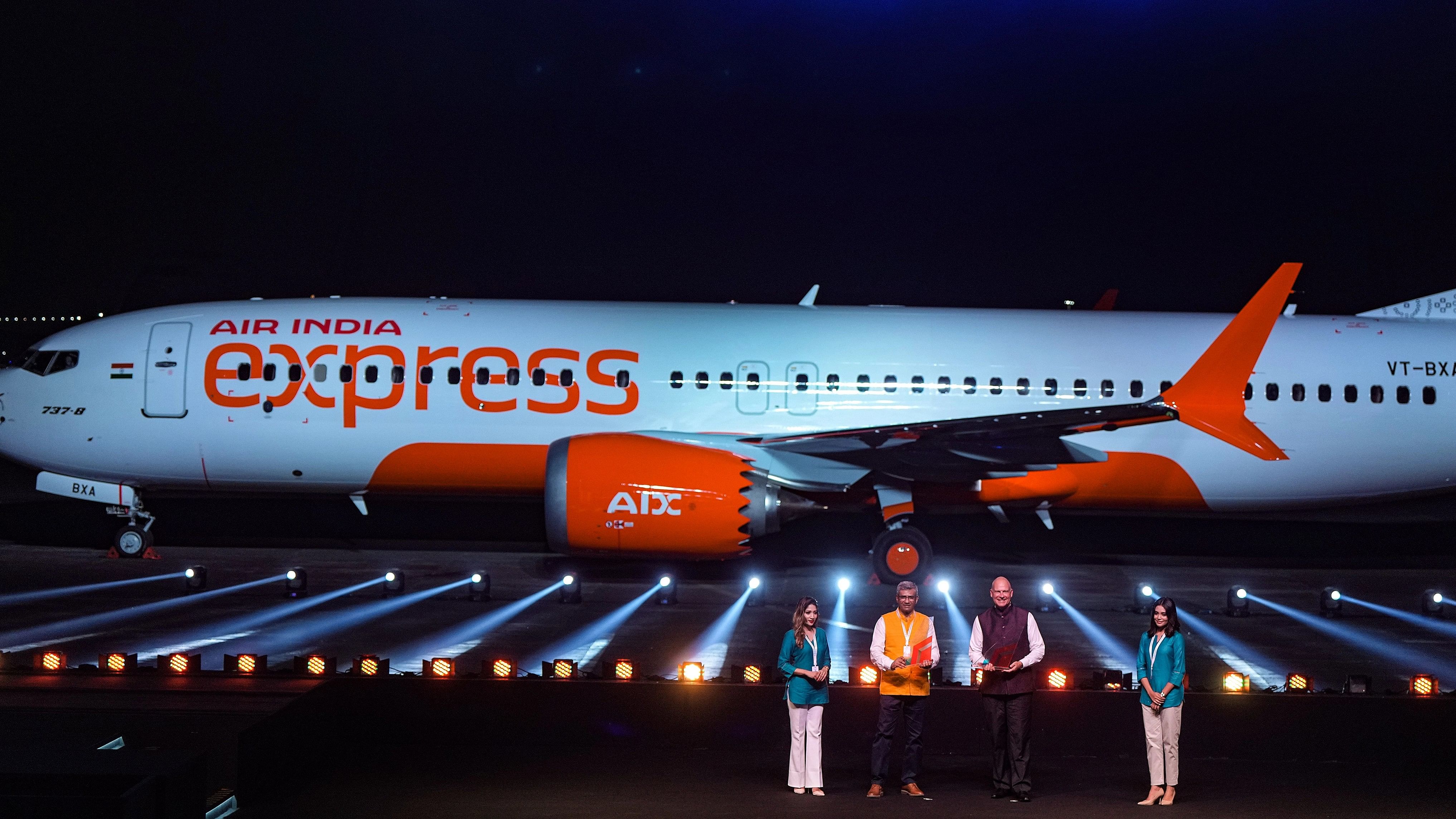 <div class="paragraphs"><p>Mumbai: Air India Expresss Chairman Campbell Wilson and MD Aloke Singh pose for photos with the Tata Group-owned Air India Express (AIX) flight during the unveiling of its new brand identity and aircraft livery, in Mumbai, Wednesday, Oct. 18, 2023. </p></div>