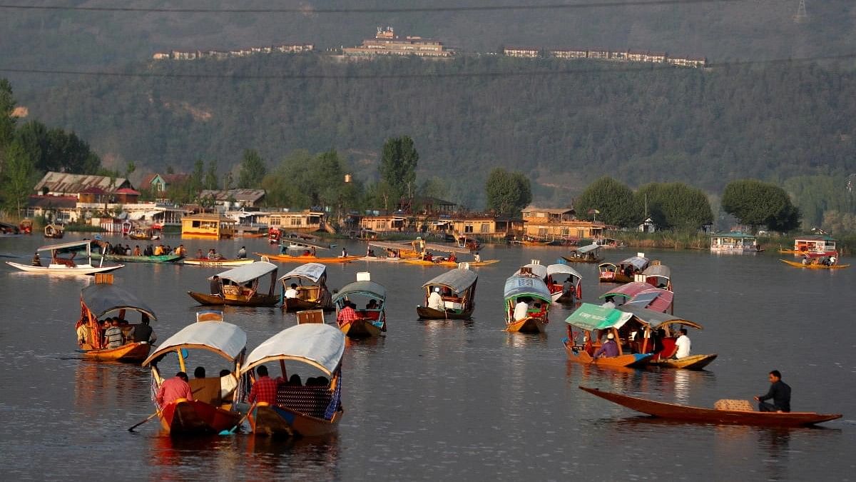 <div class="paragraphs"><p>Tourists ride "Shikaras" or boats in the waters of Dal Lake in Srinagar.</p></div>