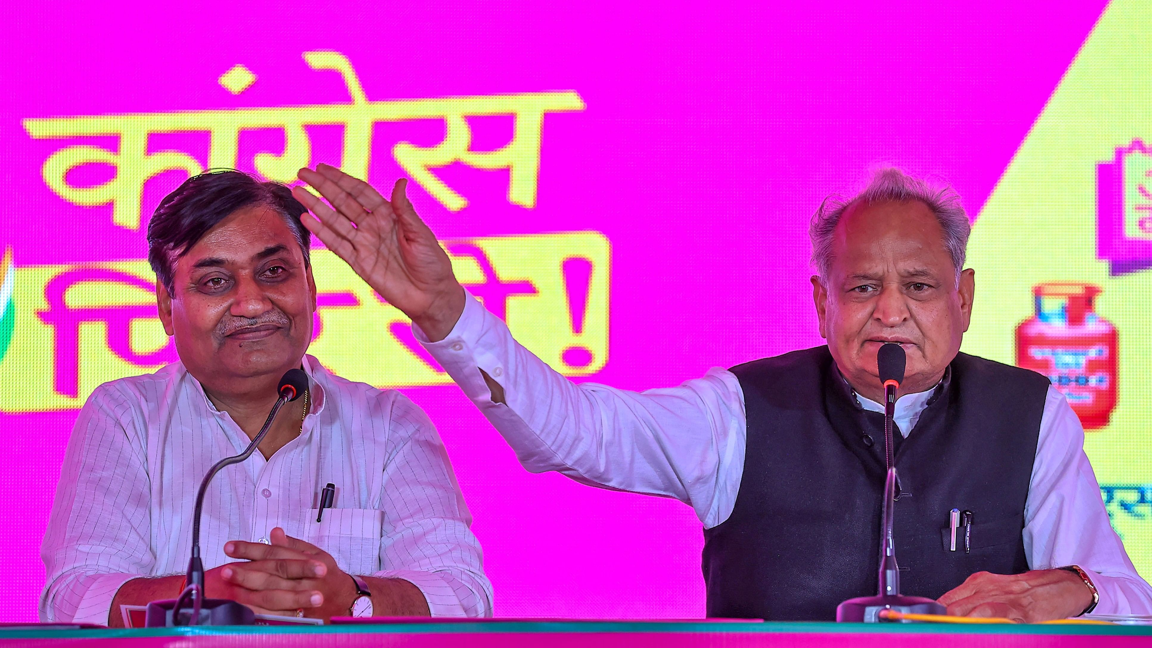 <div class="paragraphs"><p>Rajasthan Chief Minister Ashok Gehlot with Rajasthan Congress president Govind Singh Dotasra addresses a press conference during the launch of the party's 7 guarantees ahead of the state assembly elections, in Jaipur, Friday, Oct. 27, 2023. </p></div>